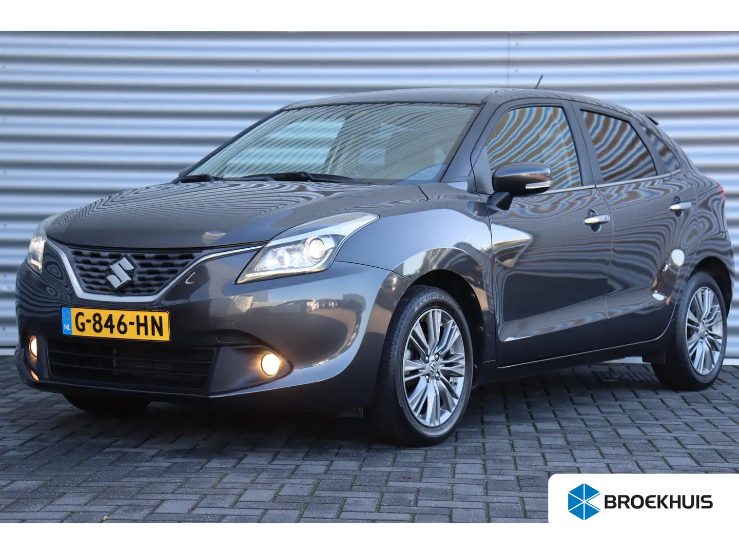 Suzuki Baleno 1.2 89PK HIGH EXECUTIVE AUTOMAAT / NAVI / CLIMA / Grijs - 1