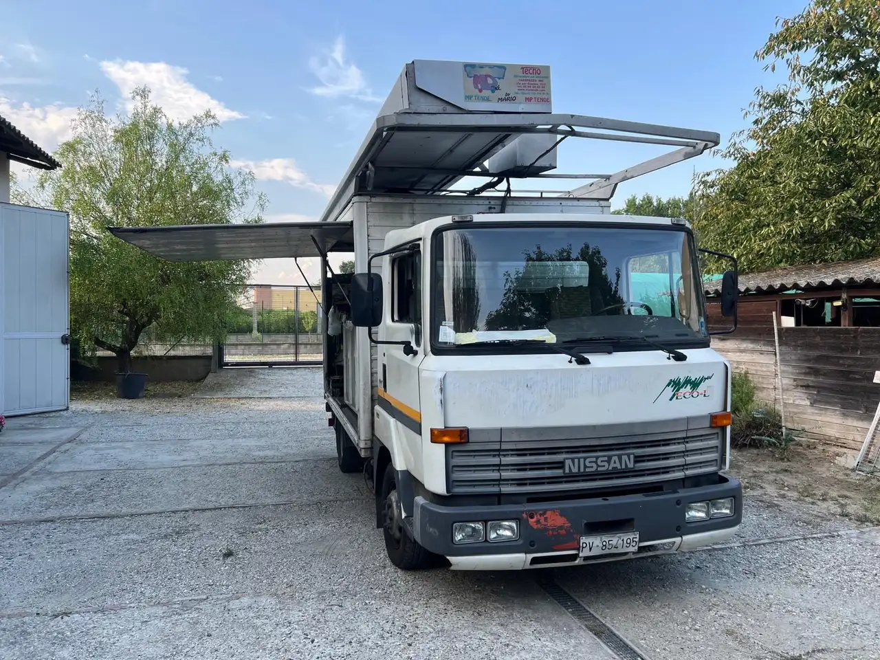 NISSAN L50 CON SPONDA E TENDA ELETTRICA, foto 2
