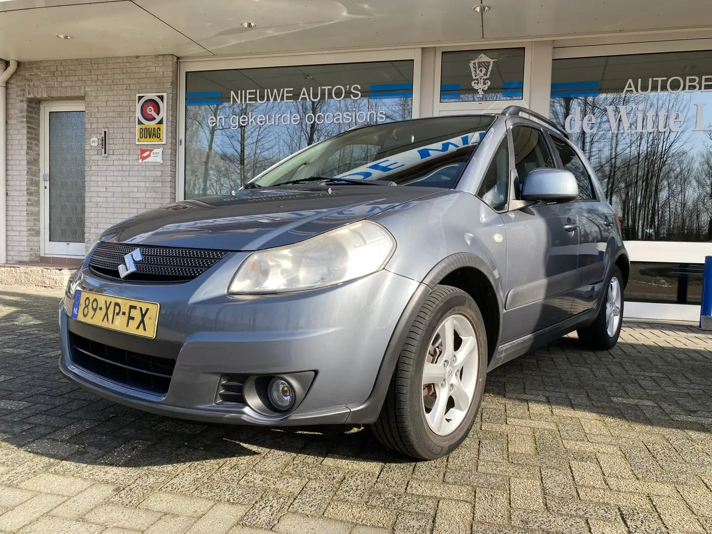 Suzuki SX4 1.6 Shogun Aneemb. trekhaak/Airco/Hoogte verst.b. Grau - 1