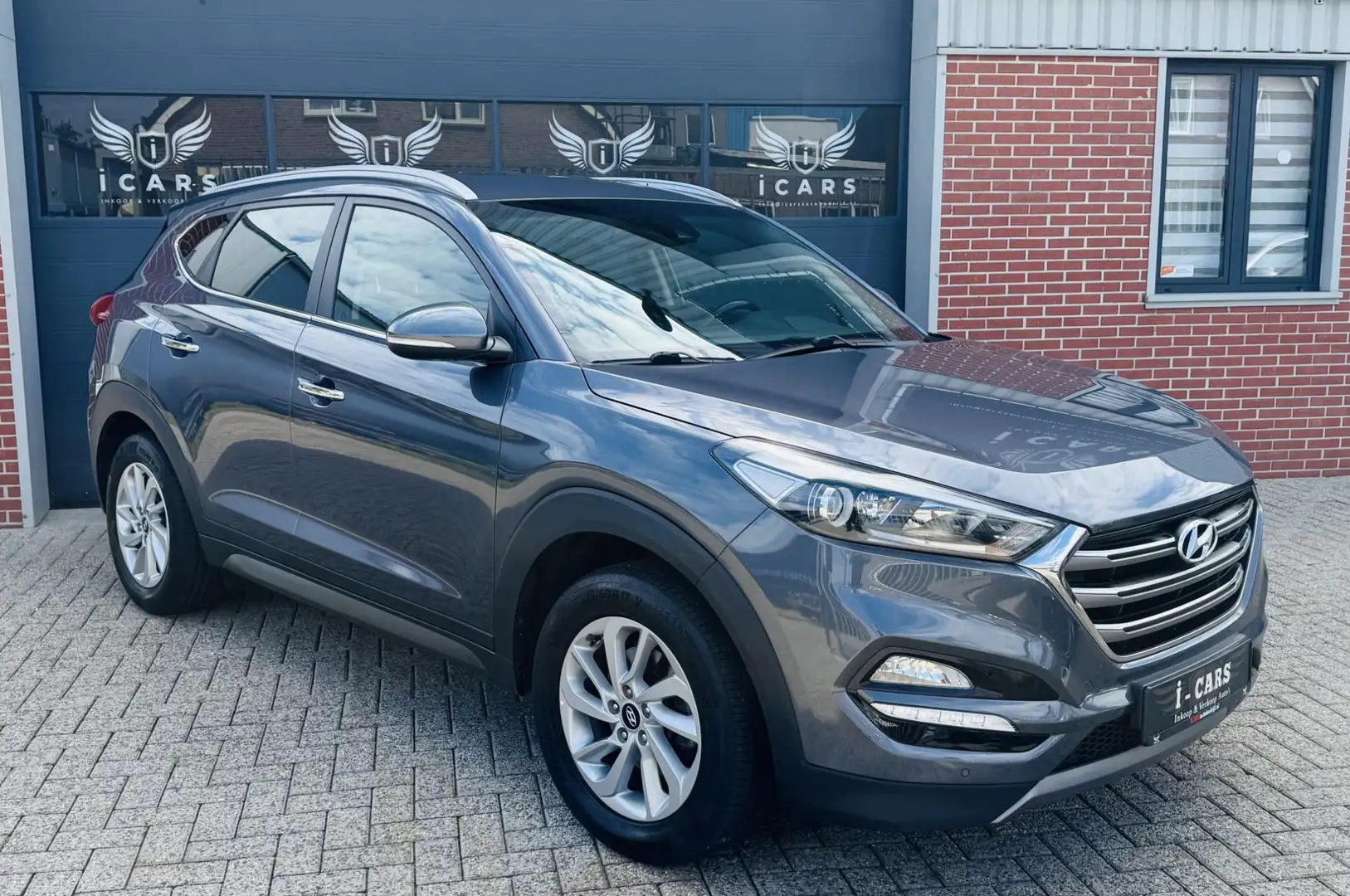 Hyundai TUCSON 1.6 GDi LEER/NAVI/CAMERA Dealer onderhouden Grijs - 1