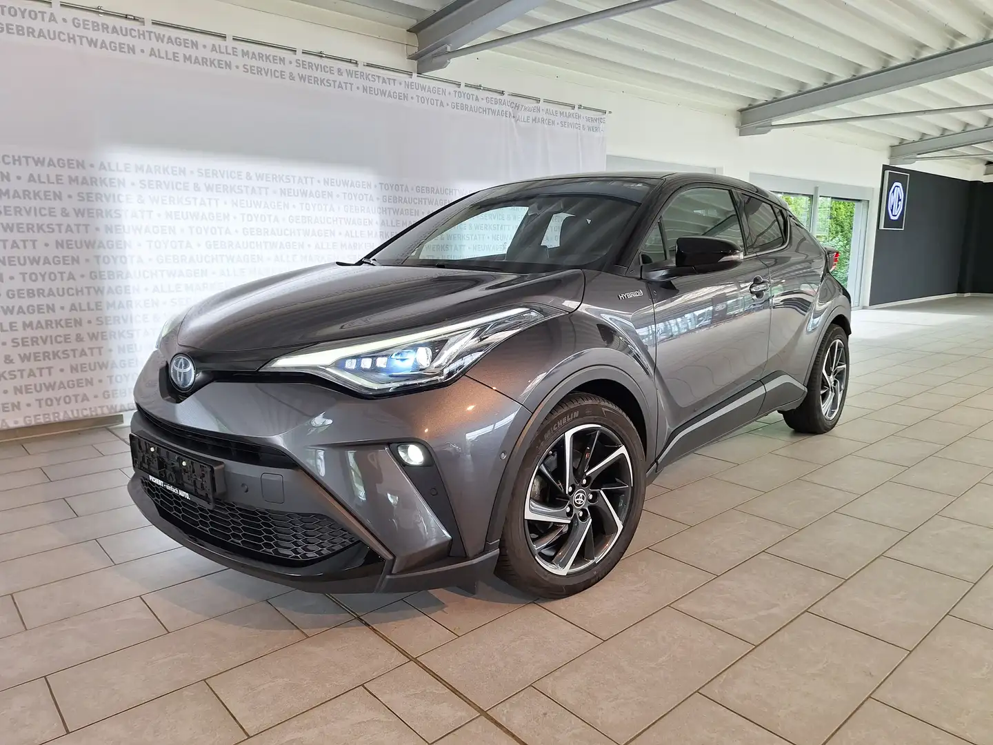 Toyota C-HR 2,0 Hybrid Style Selection Lenkrad/Sitzheizung Garantie Serviceheft Navi Kamera, wie GR Sport nur mit 18" Alufelgen Grau - 1