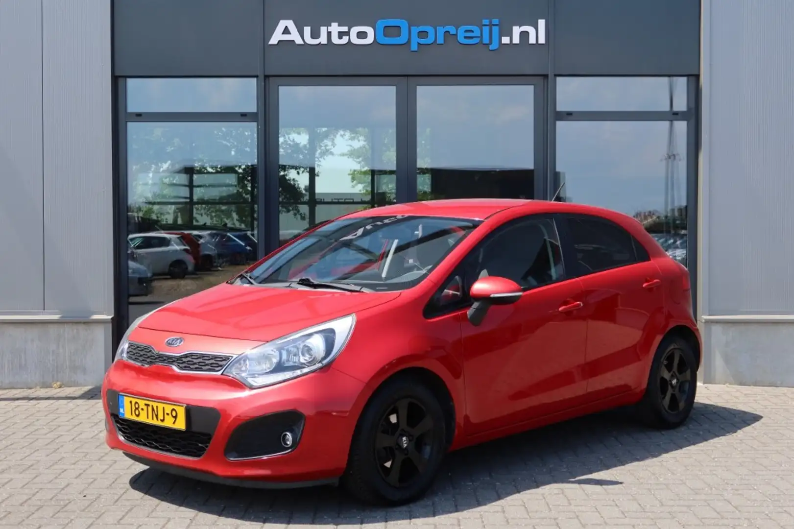 Kia Rio 1.2 CVVT Plus Pack 5drs. Airco, Trekhaak afnb. Rood - 1