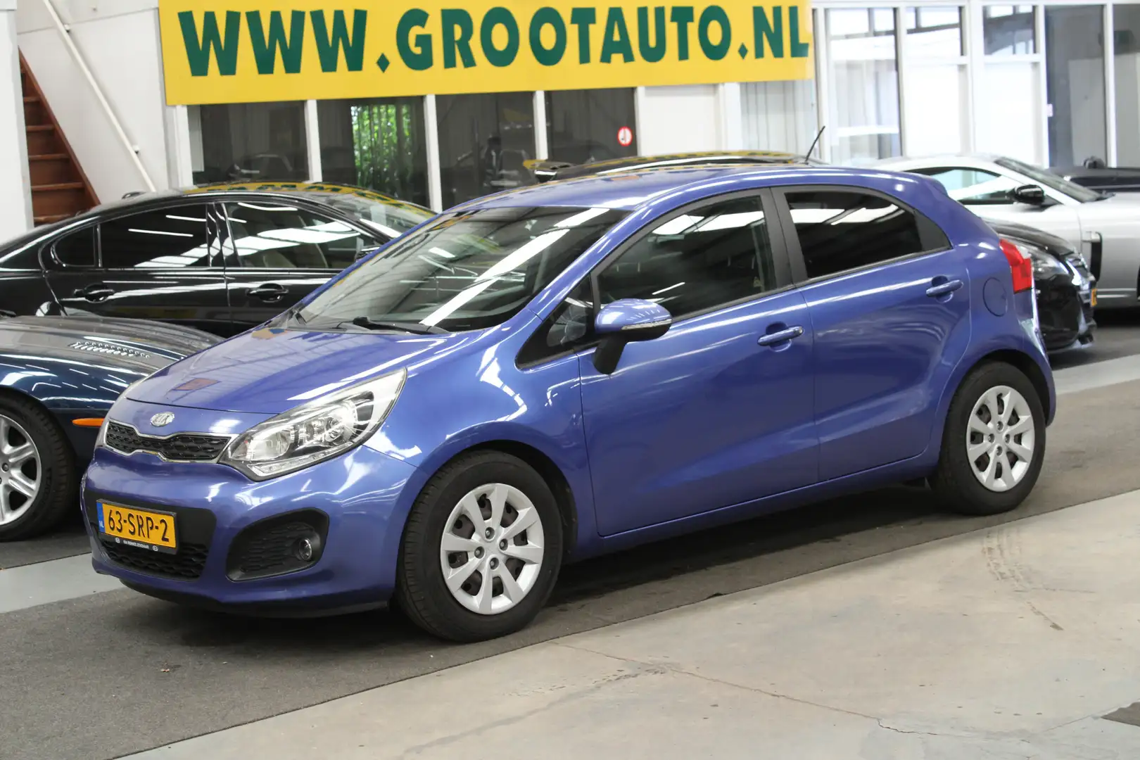 Kia Rio 1.2 CVVT Super Pack Airco, Cruise, NAP Azul - 1