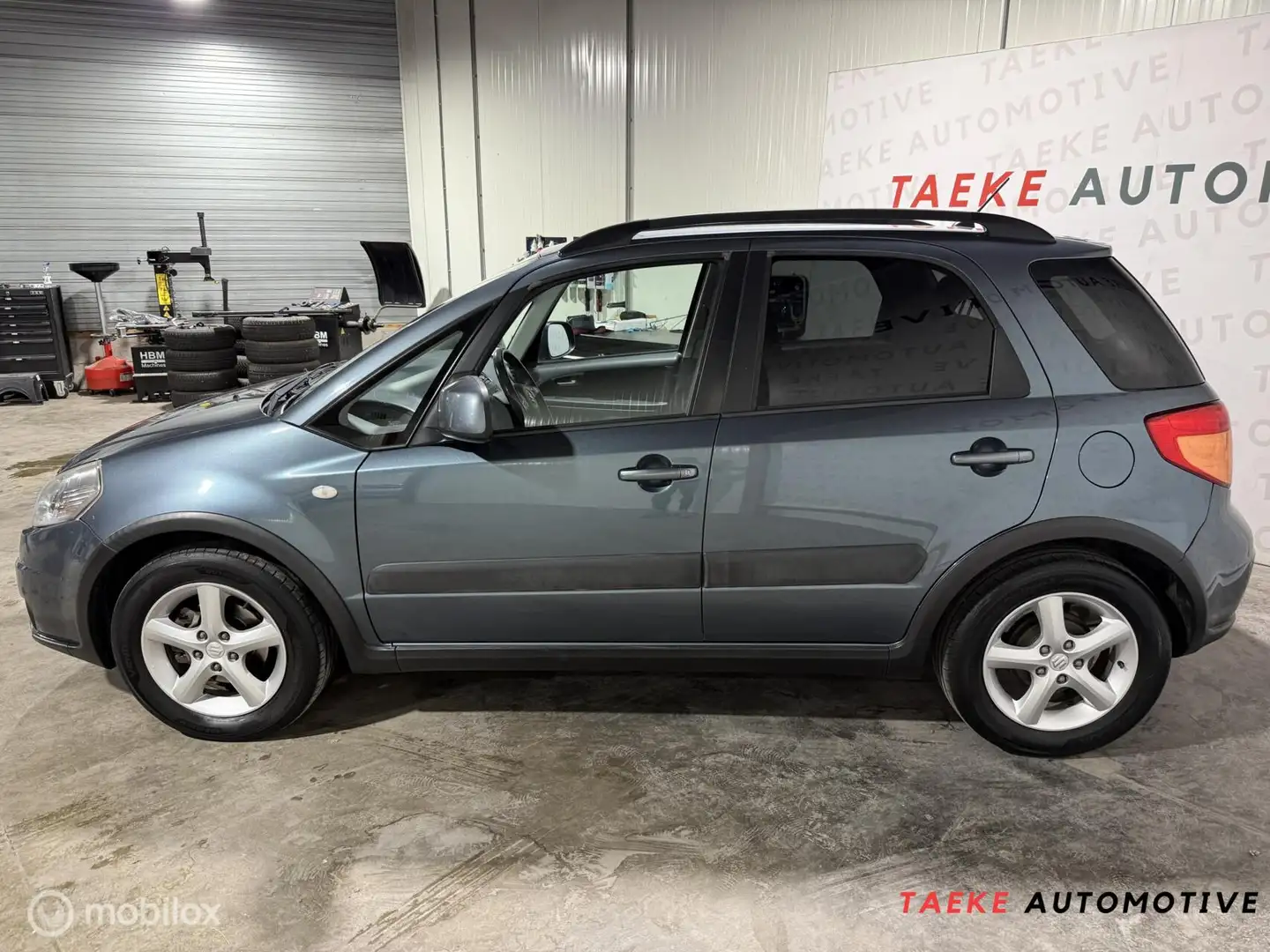 Suzuki SX4 1.6 Shogun Airco/Cruise/Nap/Parkeersen Grau - 2