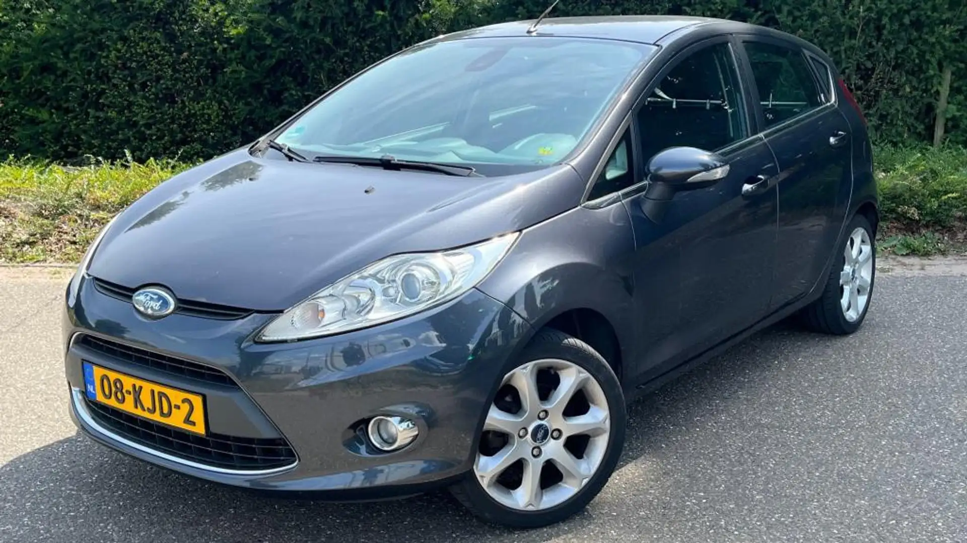 Ford Fiesta 1.25 Ghia l Cruise Control l Clima Airco l NAP l Gris - 1