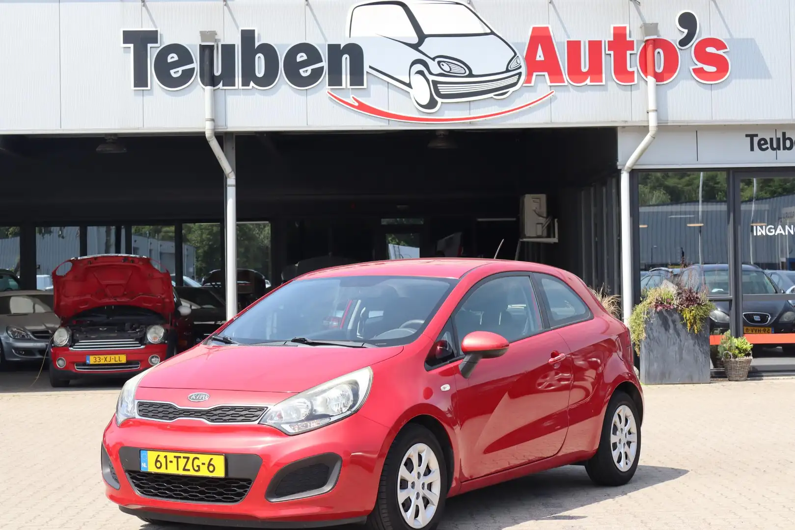 Kia Rio 1.2 CVVT Comfort Pack Airco, Radio cd speler, Elek Rosso - 1