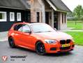 BMW 135 1-serie M135i xDrive High Executive ZEER UNIEKE AU Oranje - thumbnail 1