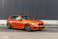 BMW 135 1-serie M135i xDrive High Executive Oranje - thumbnail 1