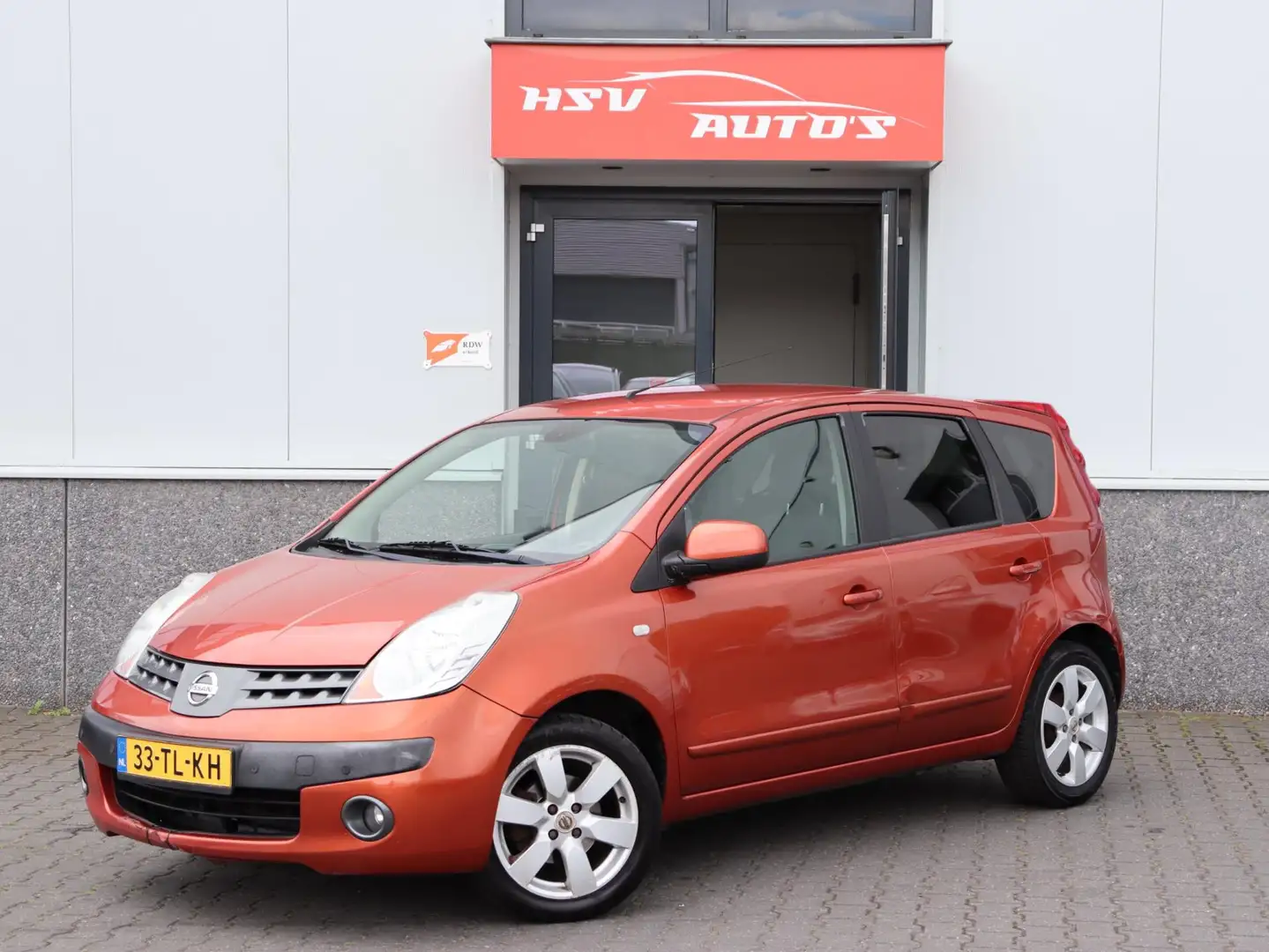 Nissan Note 1.6 Tekna automaat LM airco Oranje - 1