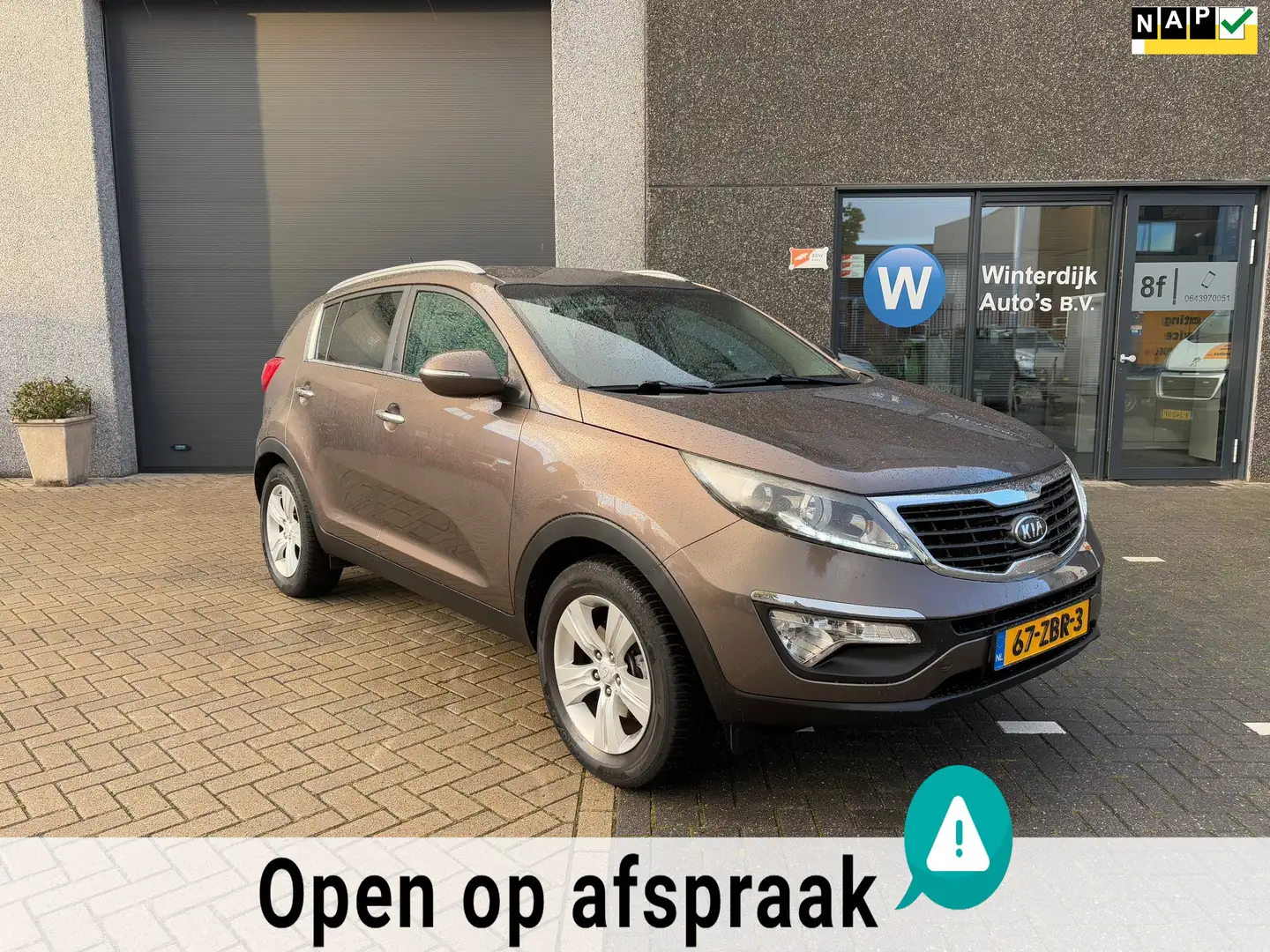 Kia Sportage 1.6 GDI Plus Pack Airco, Cruise, Trekhaak, PDC Bruin - 1