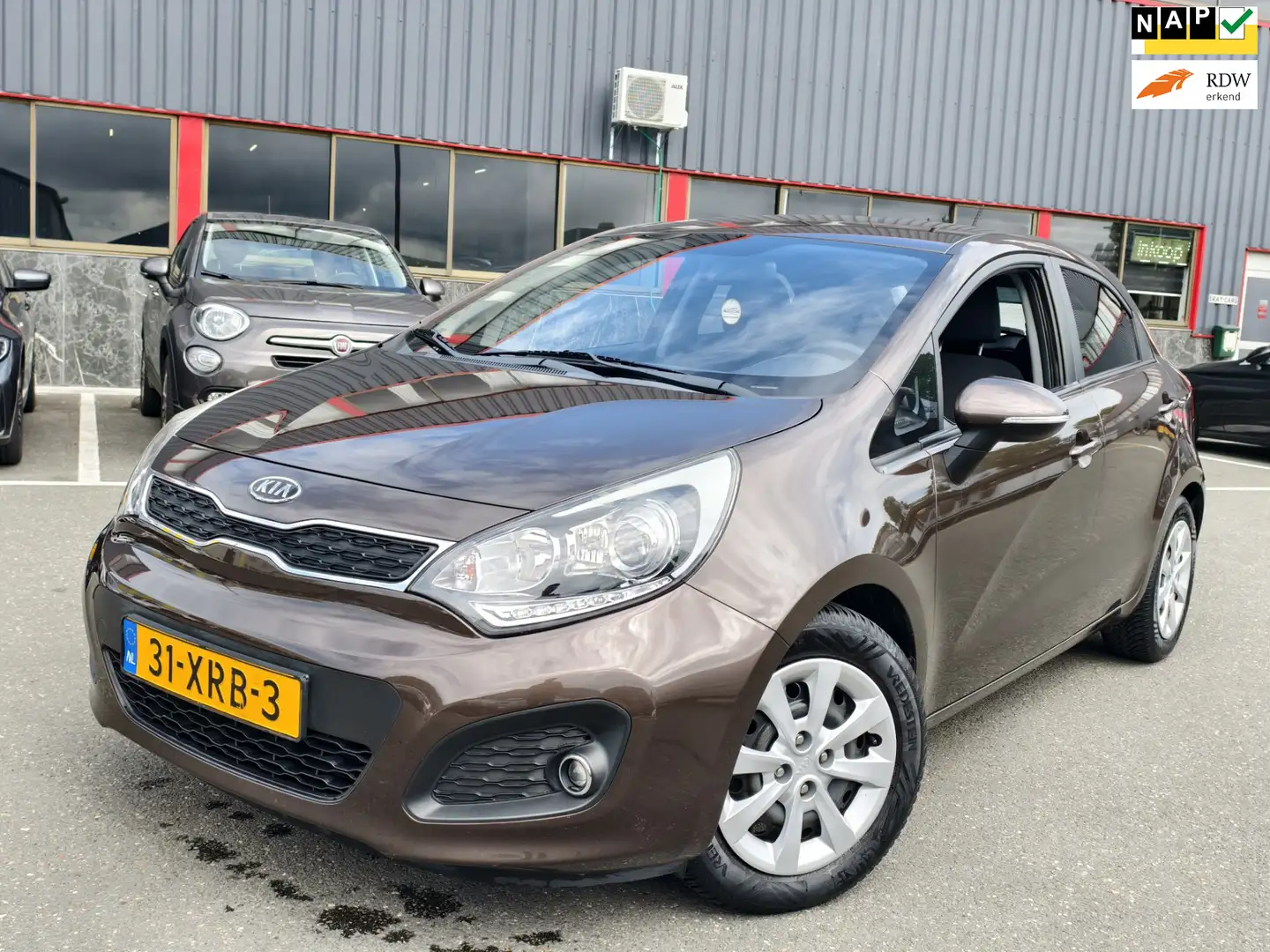 Kia Rio 1.2 CVVT Plus Pack / NAP / AIRCO / PDC / OHB / Brown - 1