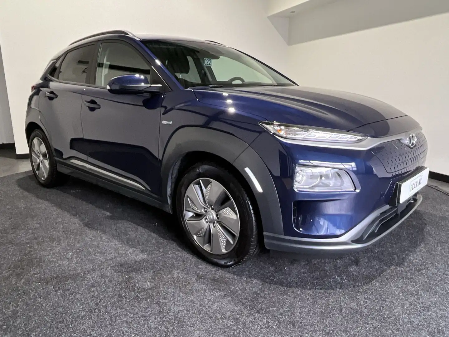 Hyundai KONA EV Fashion 64 kWh | Warmtepomp | Open Dak | Naviga Blauw - 1