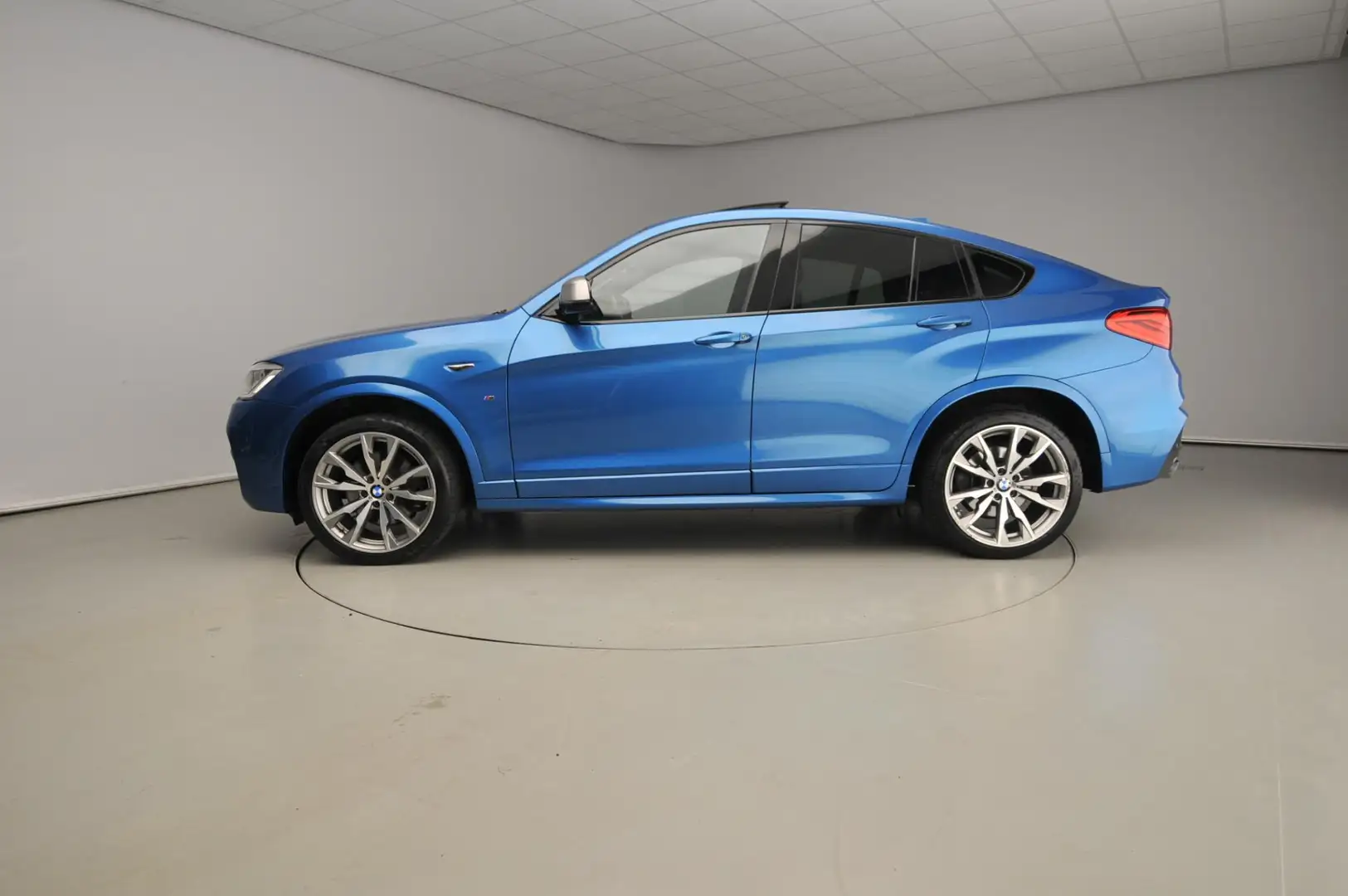 BMW X4 M40i | M-Sportpakket | LED | Leder | HUD | Active Blauw - 2