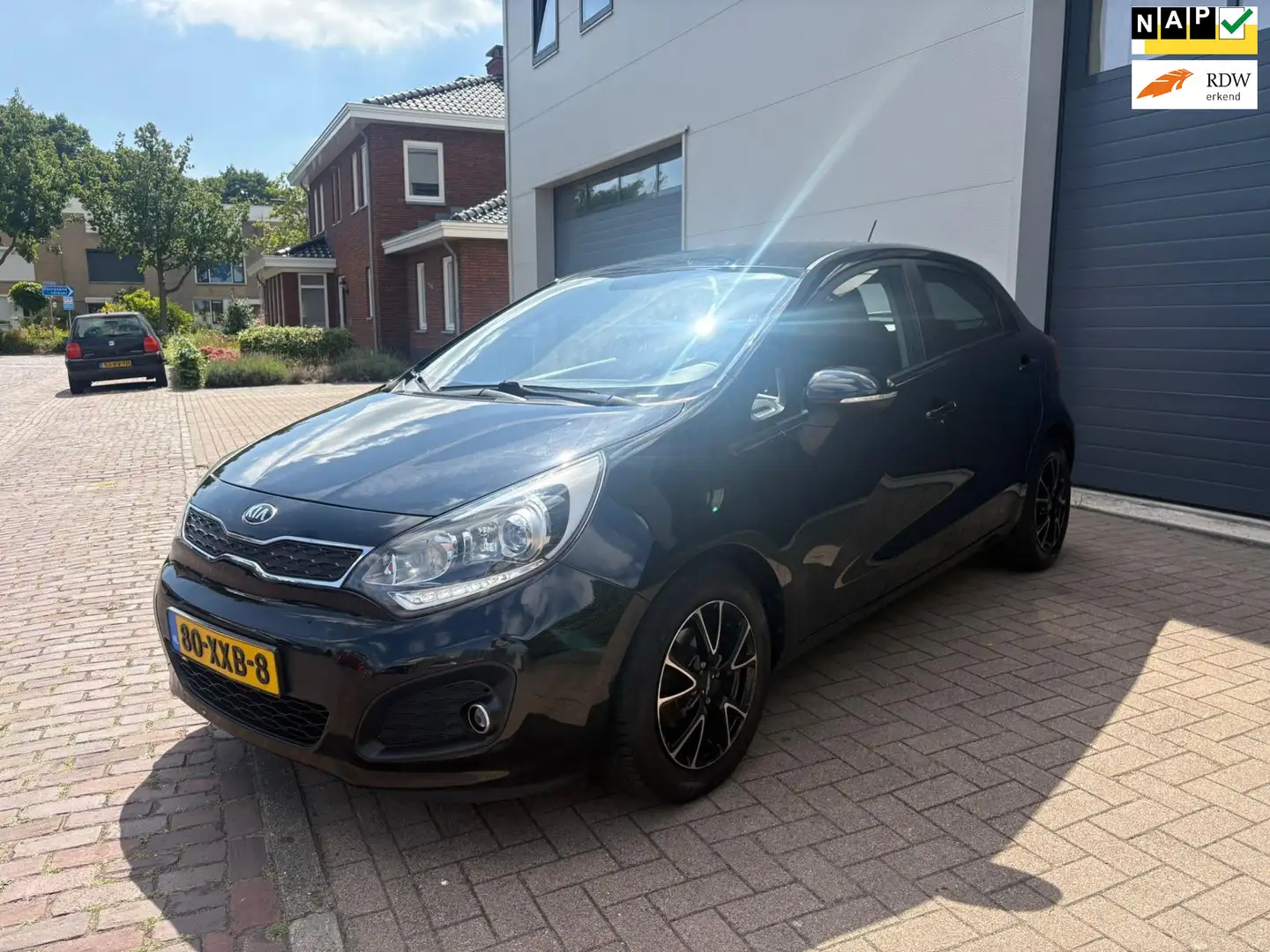Kia Rio 1.2 CVVT Plus Pack/2e eigenaar/Airco/AUX/LED/Elek- Zwart - 1