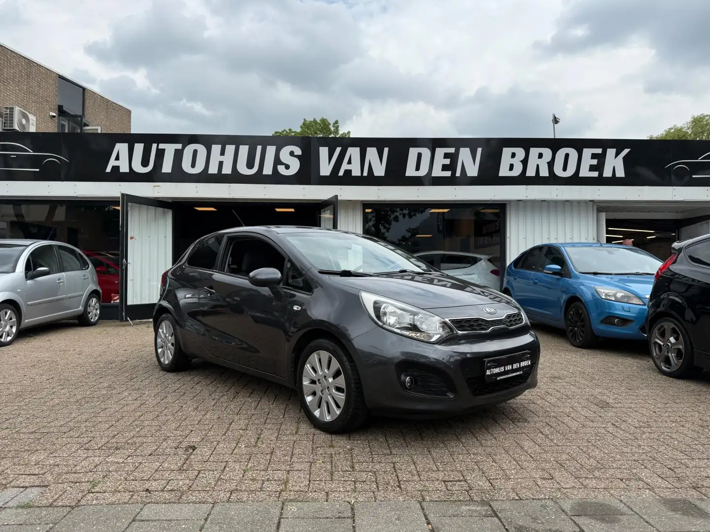 Kia Rio 1.2 CVVT Comfort Pack|Airco|Stoelverw|Pdc|Lmv|Elek Gris - 1