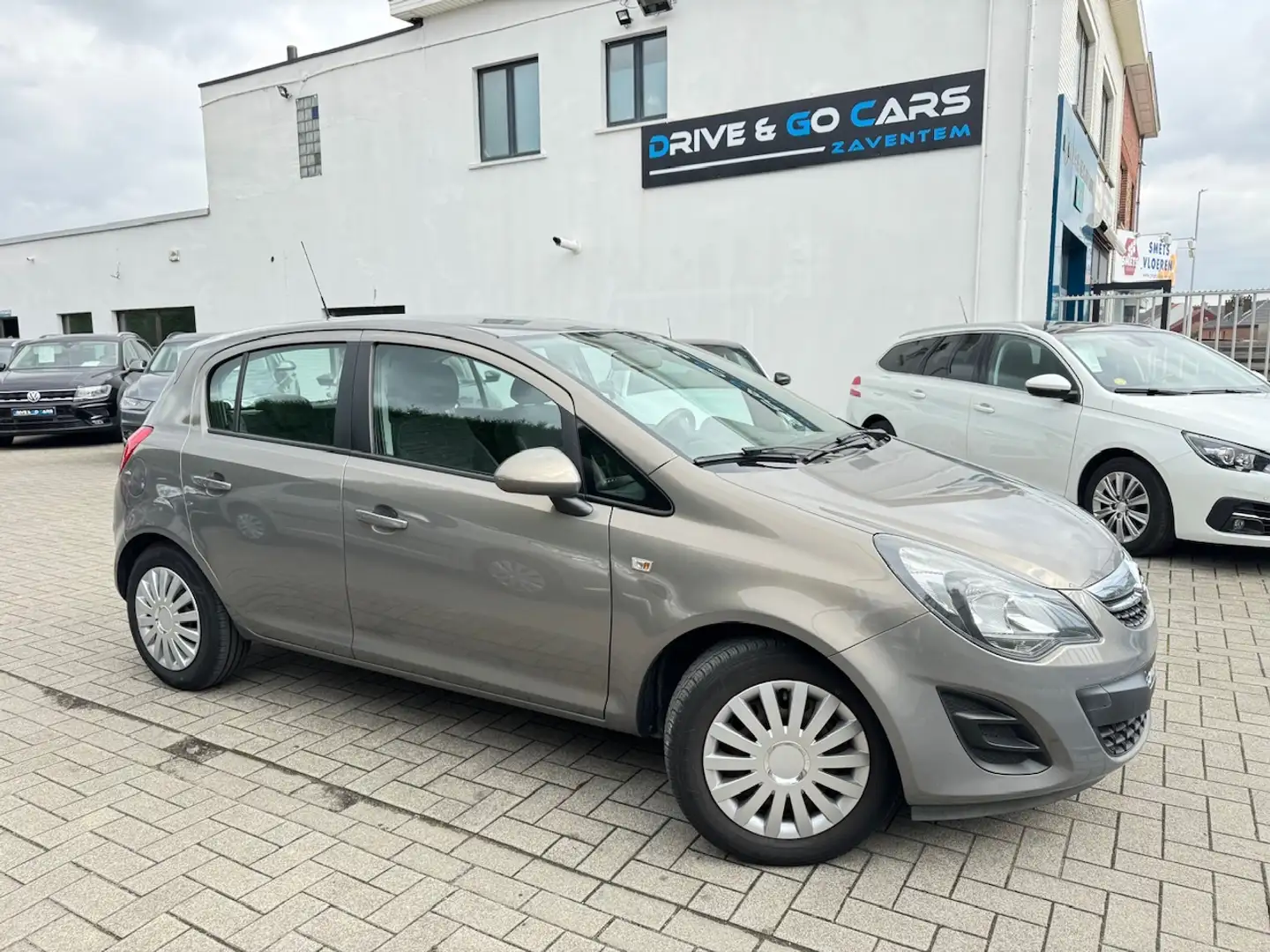 Opel Corsa 1.2i 16V Cosmo - Navigatie ** 1 JAAR GARANTIE ** Argent - 1