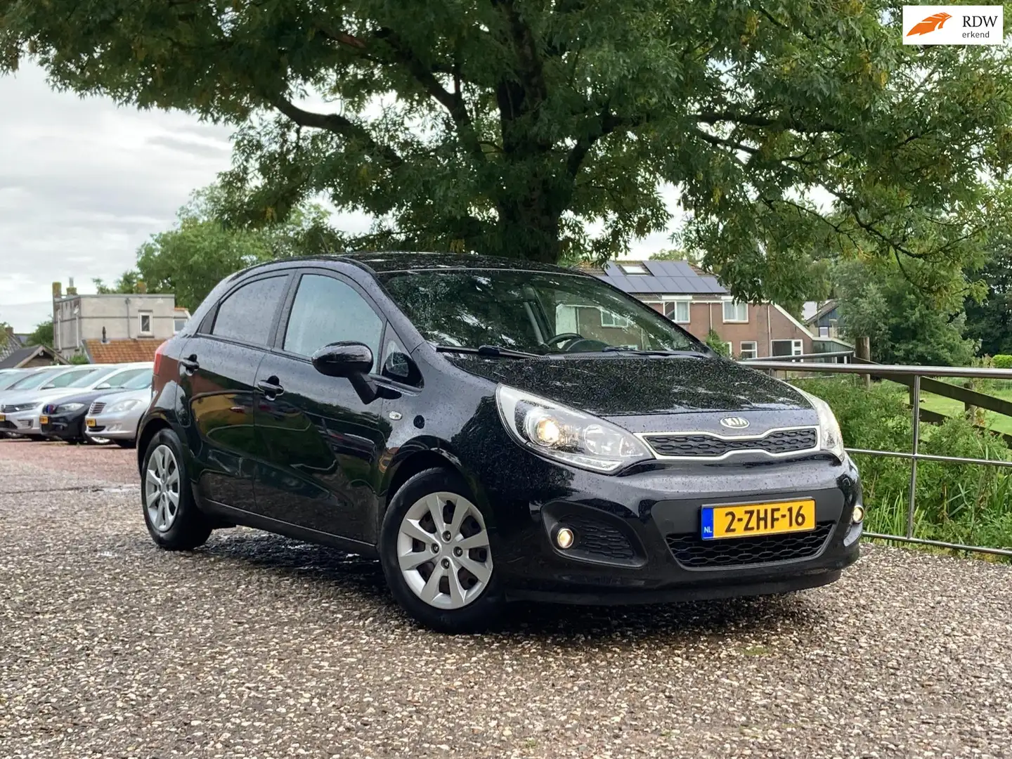 Kia Rio 1.2 CVVT BusinessLine | Navi + Airco + Cruise Nu € Zwart - 1