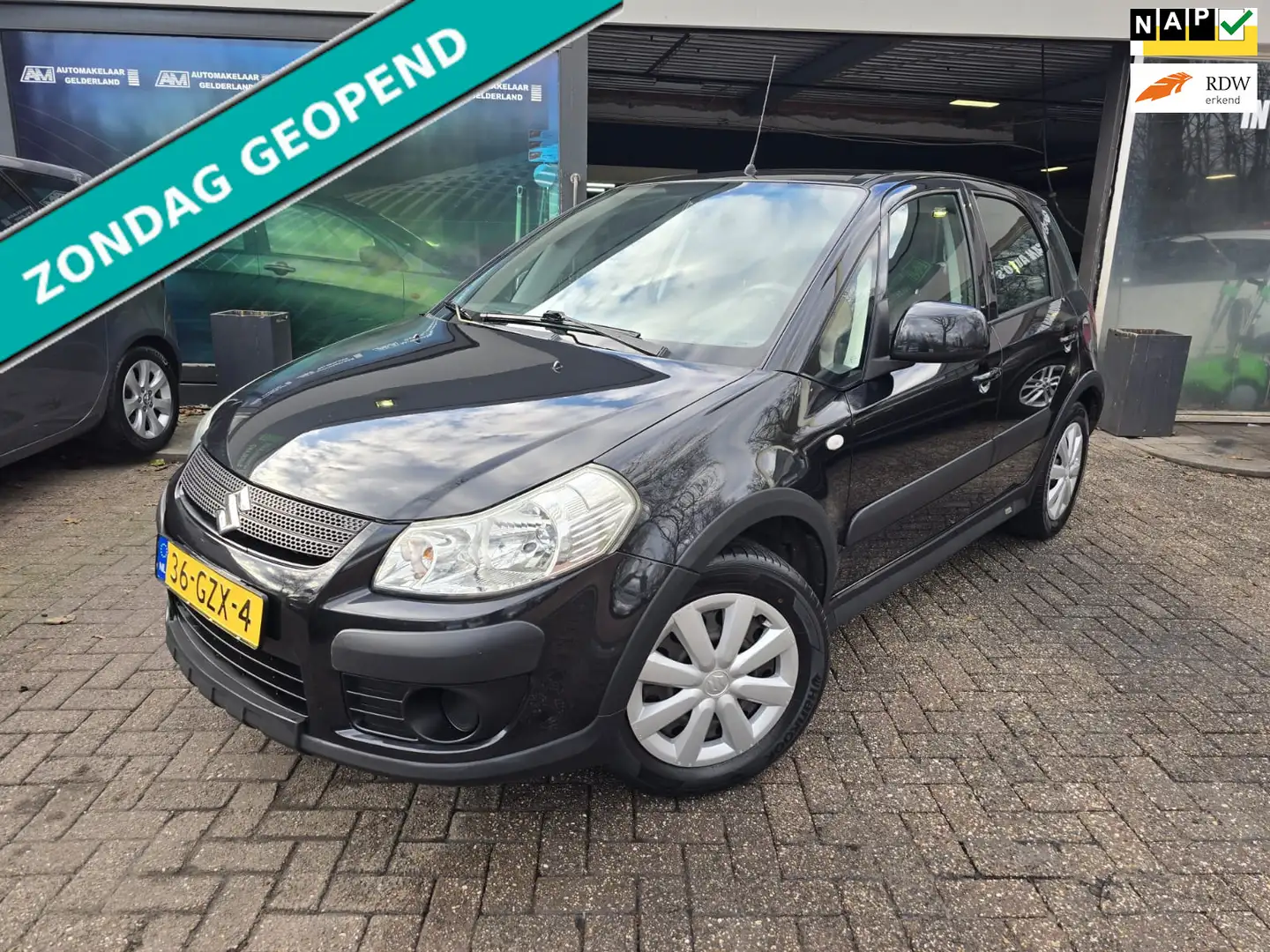 Suzuki SX4 1.6 Comfort | 12MND GARANTIE | NW APK | AIRCO | EL Zwart - 1