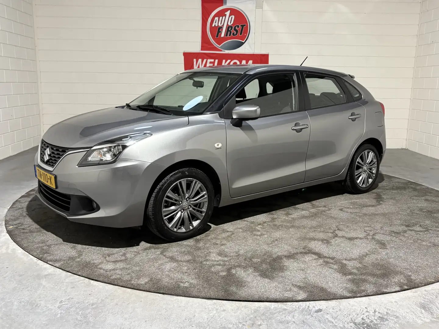Suzuki Baleno 1.2 Dynamic, Automaat, 1e eigenaar, Zuinig, Airco, Gris - 1