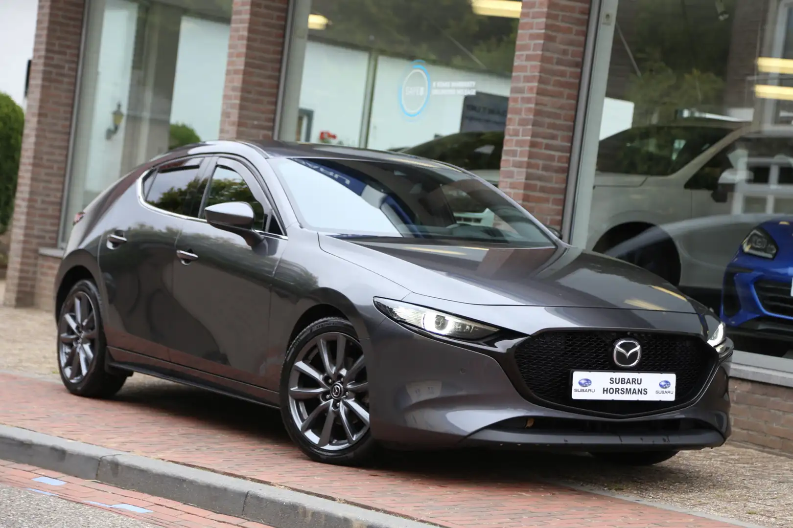 Mazda 3 2.0 e-SkyActiv-G M Hybrid l Luxury Navi HuD ACC BO Gris - 1