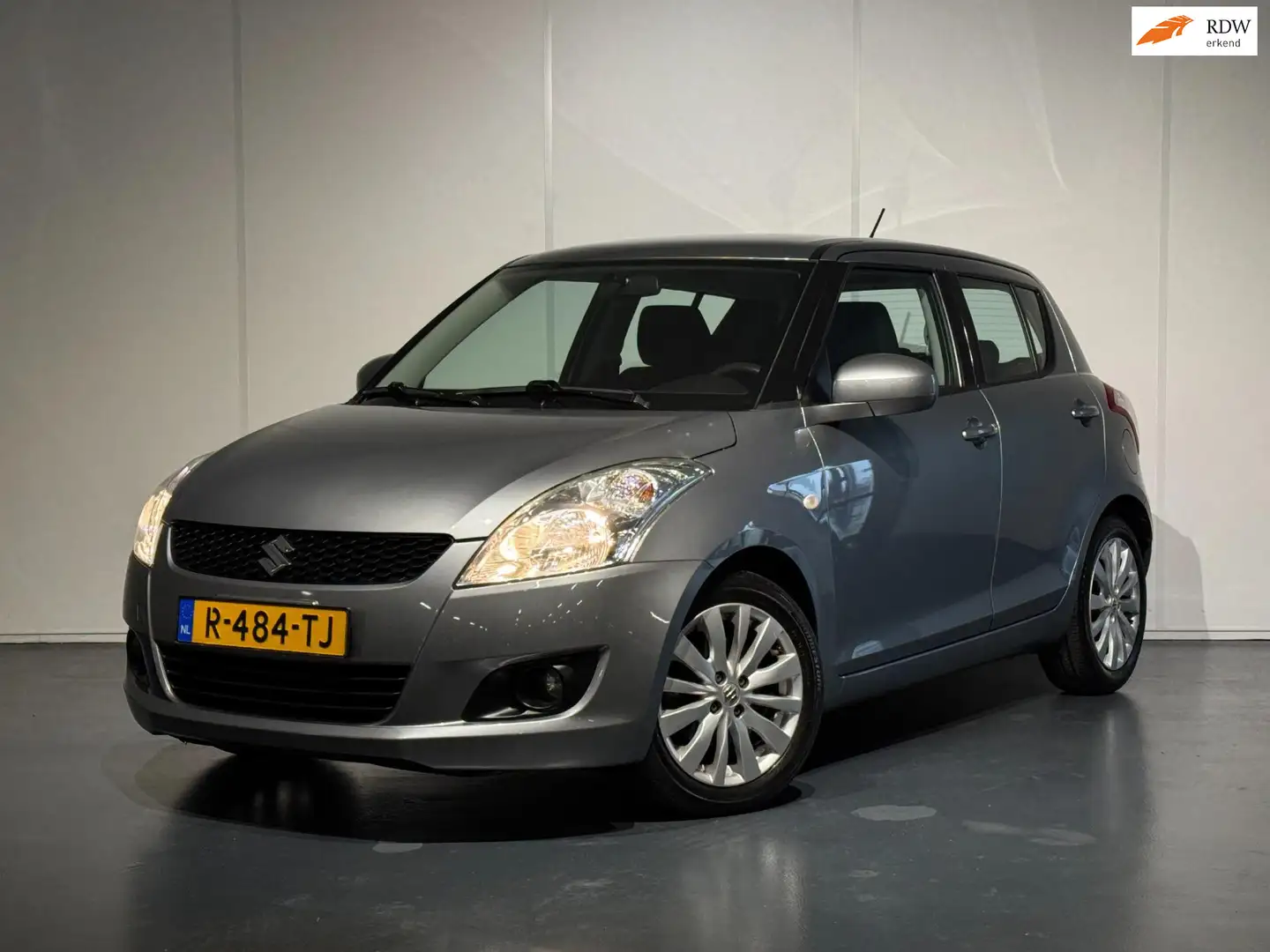 Suzuki Swift 1.2 Summer EASSS /Airco/Cruise/Keyless/Stoelverw./ Gris - 1