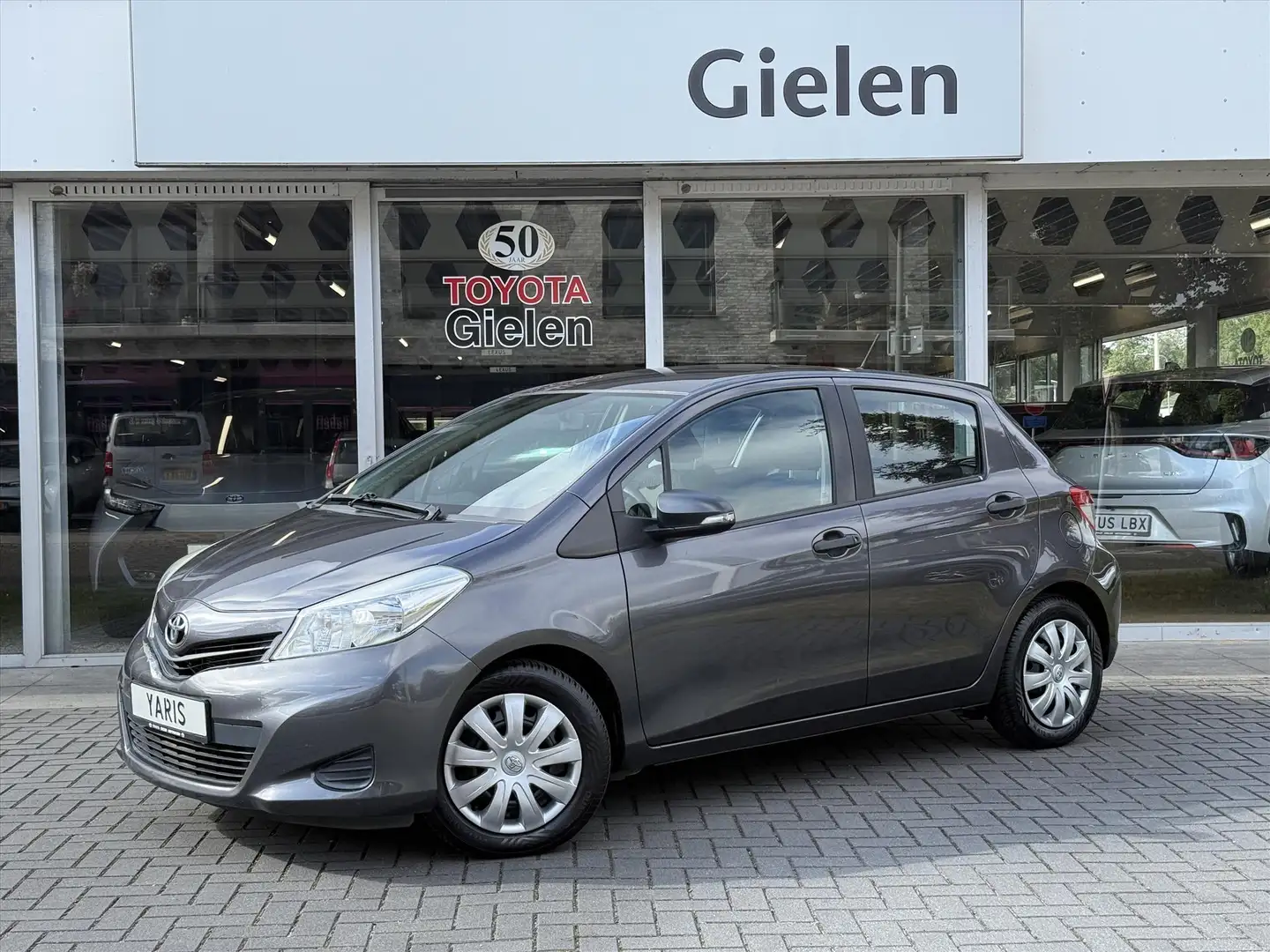 Toyota Yaris 1.0 VVT-i 5D Comfort Plus | Trekhaak, Aircondition Gris - 1