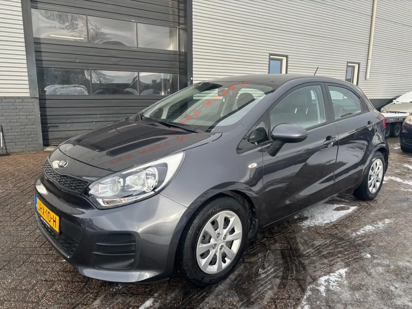Kia Rio 1.2 CVVT First Ed. 3 MND GAR | AIRCO | TREKHAAK | Grau - 1