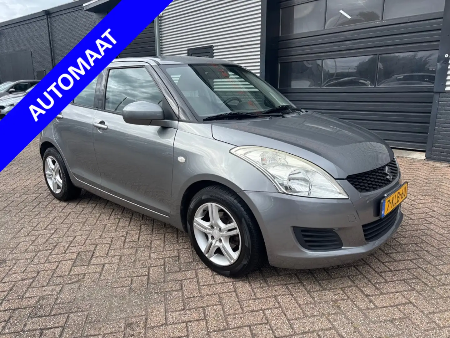 Suzuki Swift 1.2 Comfort | 3 MND GAR | AIRCO | SPORTVELGEN | EL Gris - 1