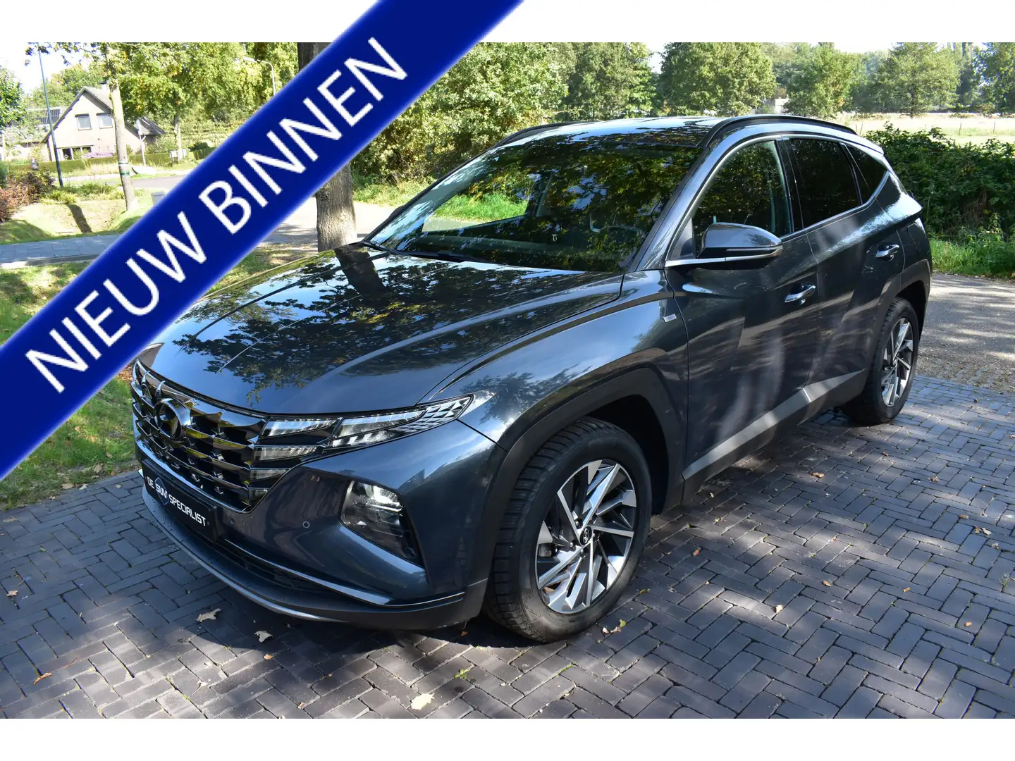 Hyundai TUCSON 1.6 T-GDI HEV Premium LEER, TREKHAAK NIEUWST. Grau - 1