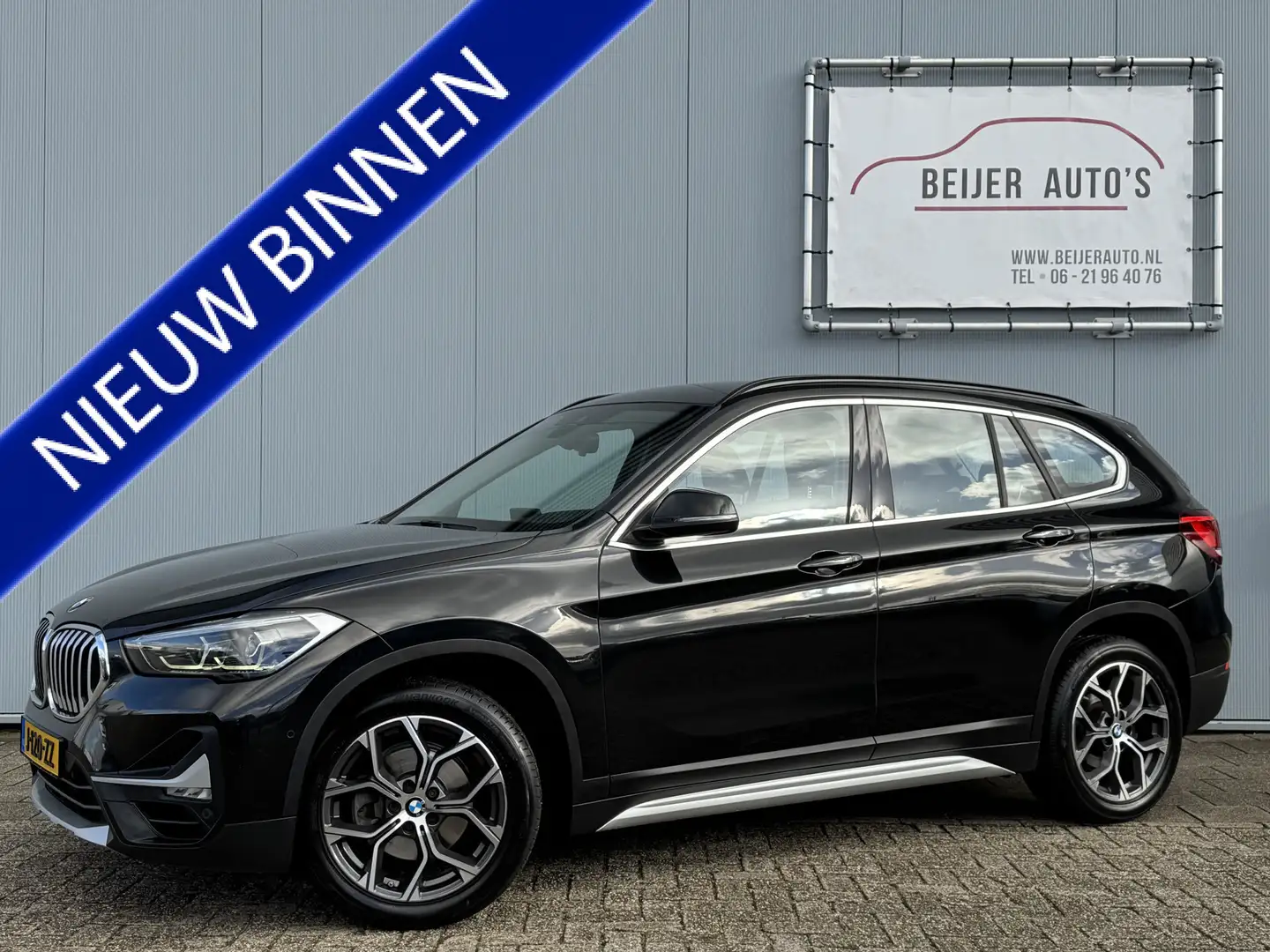 BMW X1 sDrive18i High Executive Automaat/Trekhaak/Camera/ Zwart - 1