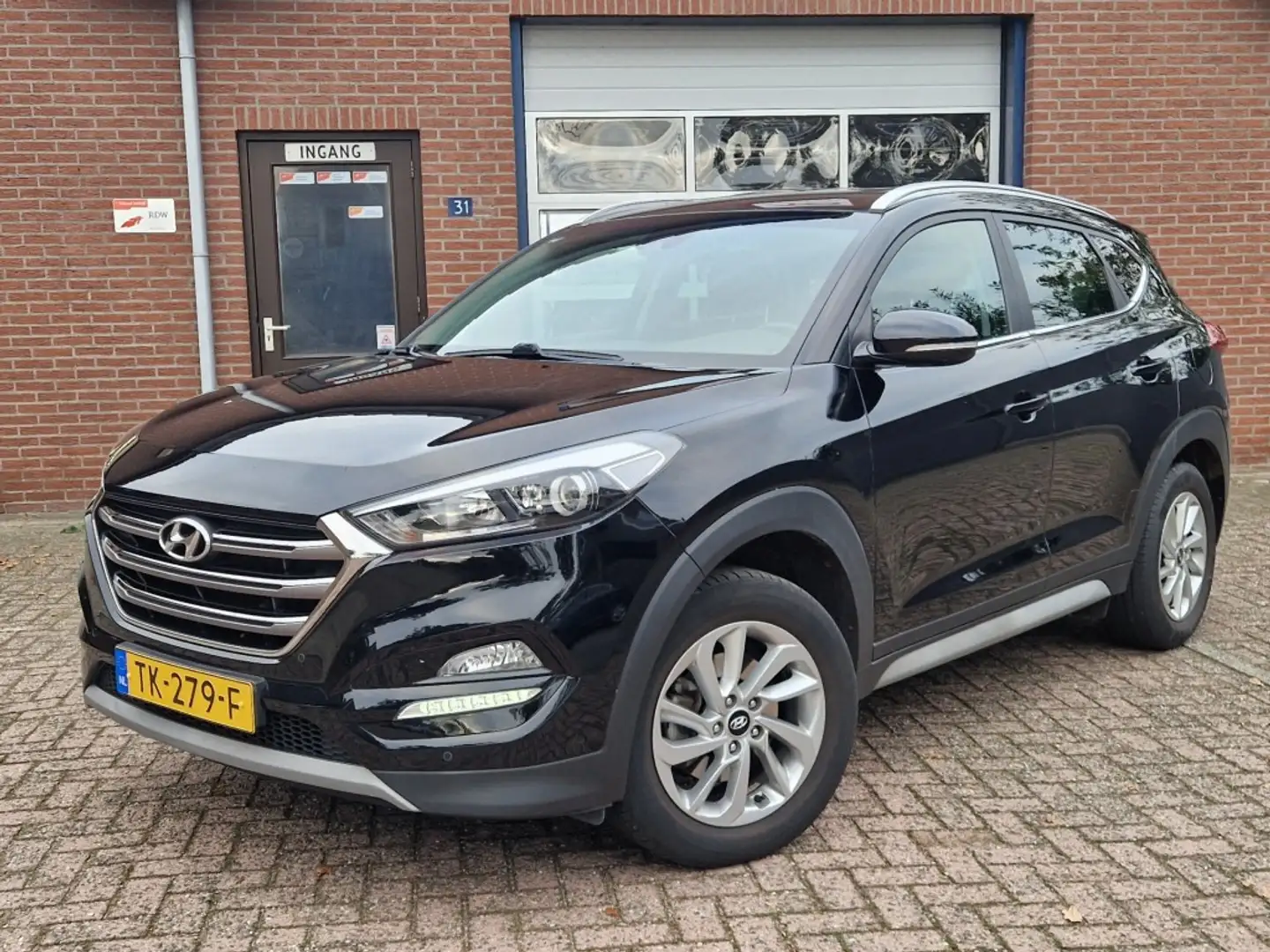 Hyundai TUCSON 1.6 GDI Comfort NL-auto Navi Clima Cruise Camera Noir - 1