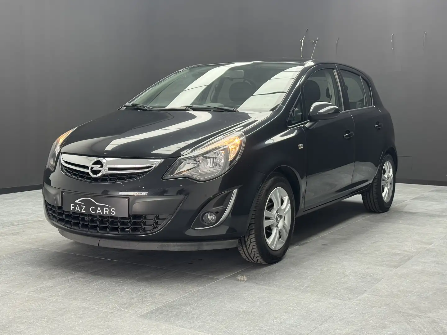 Opel Corsa 1.2i Enjoy * 1ER PROP + CLIM + JANTES + GARANTIE * Zwart - 2