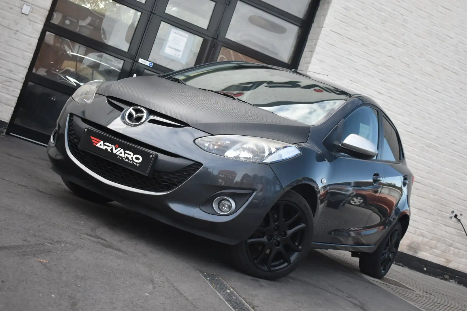 Mazda 2 1.3i Car Play / Navi / PDC / Airco / Garantie Gris - 1