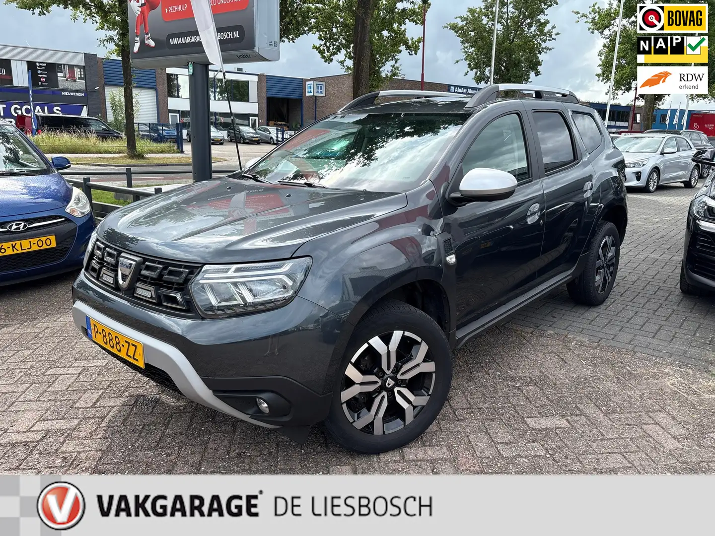 Dacia Duster 1.3 TCe Prestige automaat / navi / leer / camera / Grijs - 1