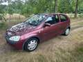Opel Corsa 1.2-16V Comfort apk t/m 29-09-2025 Rood - thumbnail 1