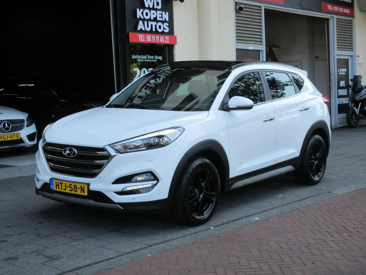 Hyundai TUCSON 1.6 T-GDi Comfort 4WD Aut Leer Navi Camera Carplay Wit - 1