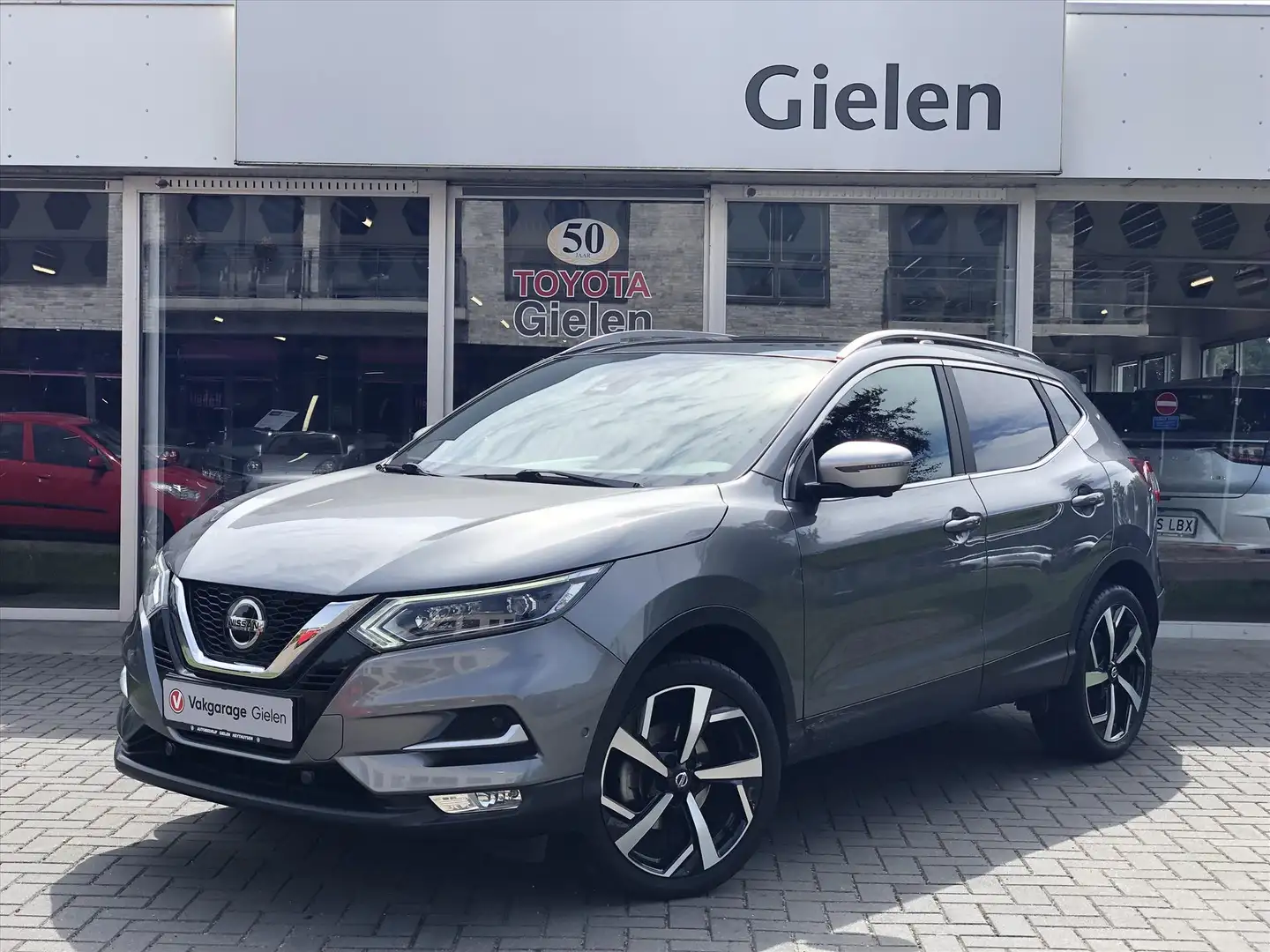 Nissan Qashqai 1.2 DIG-T Tekna+ | Eerste eigenaar, Trekhaak, Bose Gris - 1