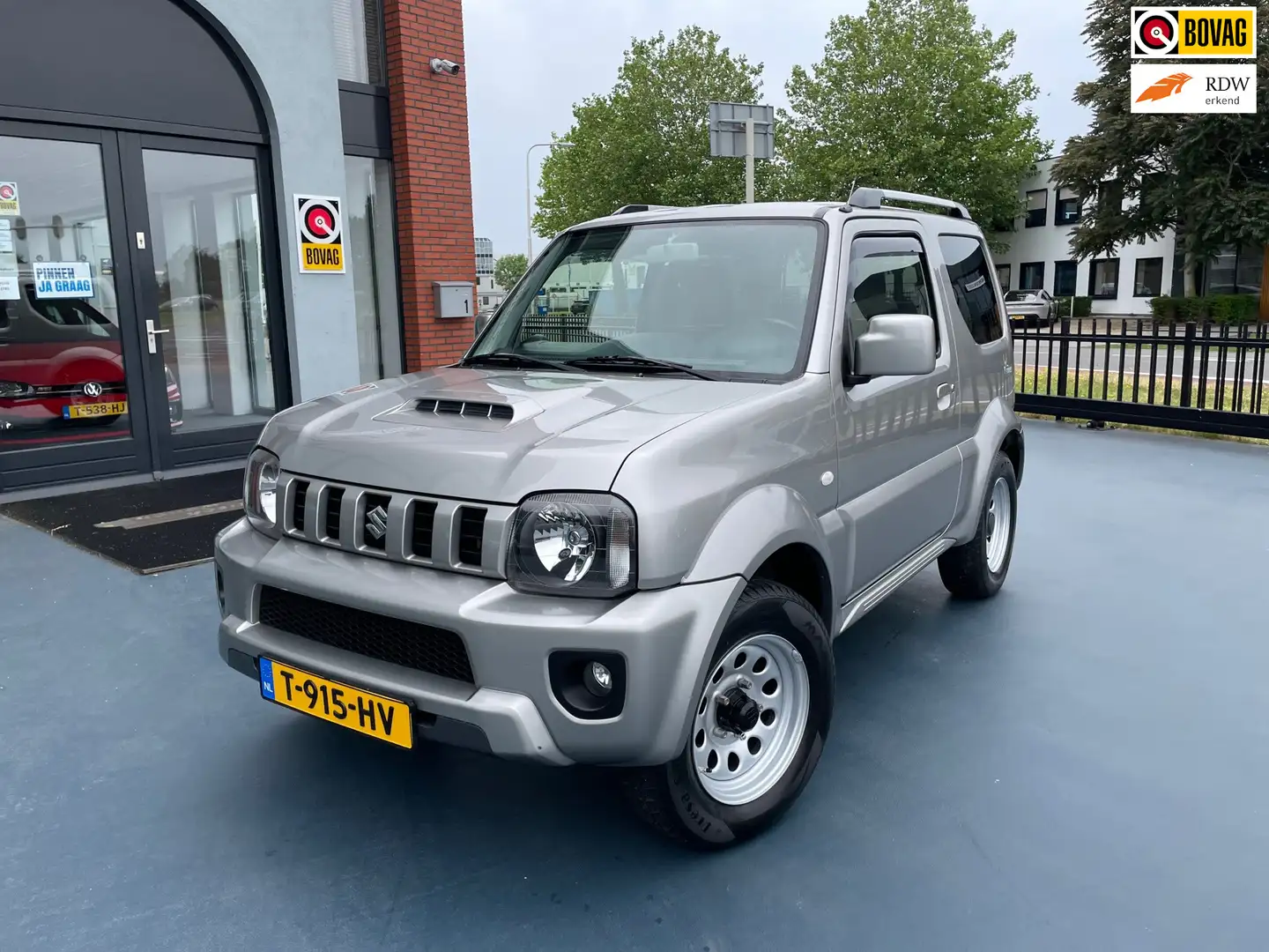 Suzuki Jimny 1.3 Exclusive 4x4 LEER STOLEVERWARMING AIRCO Grau - 1