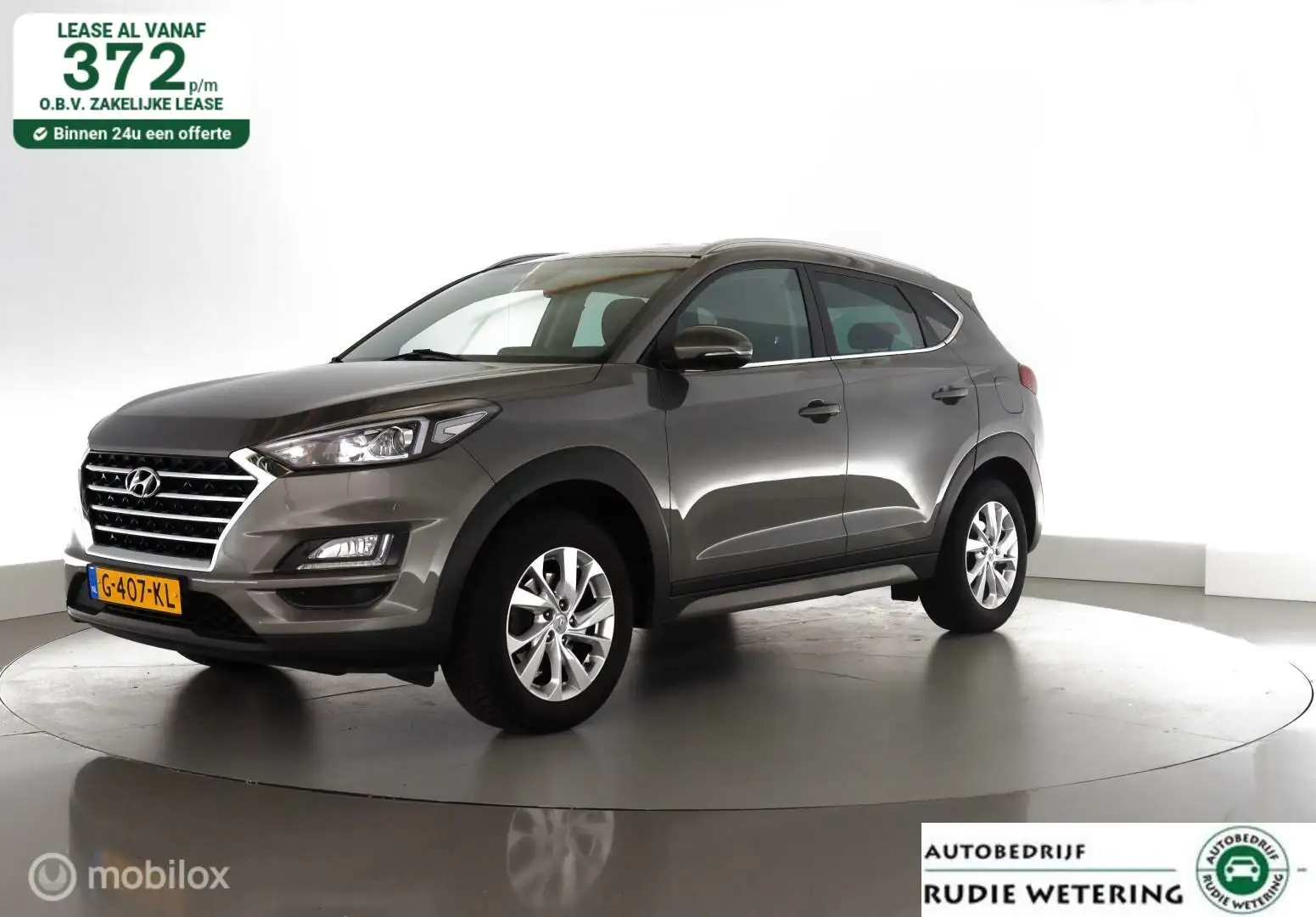 Hyundai TUCSON 1.6 GDI 131pk Comfort trekhaak|cam|nav|dab|ecc|lmv Gris - 1