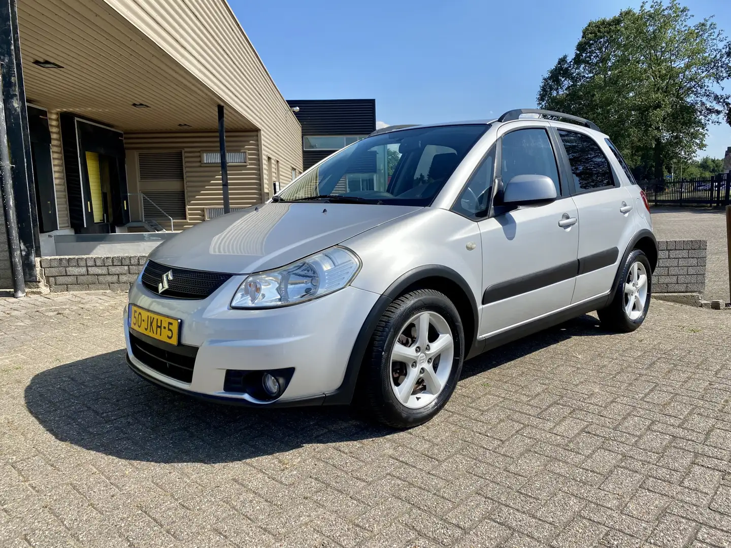 Suzuki SX4 1.6 Shogun [ 1e eig,airco,audio,lmv ] Grijs - 1