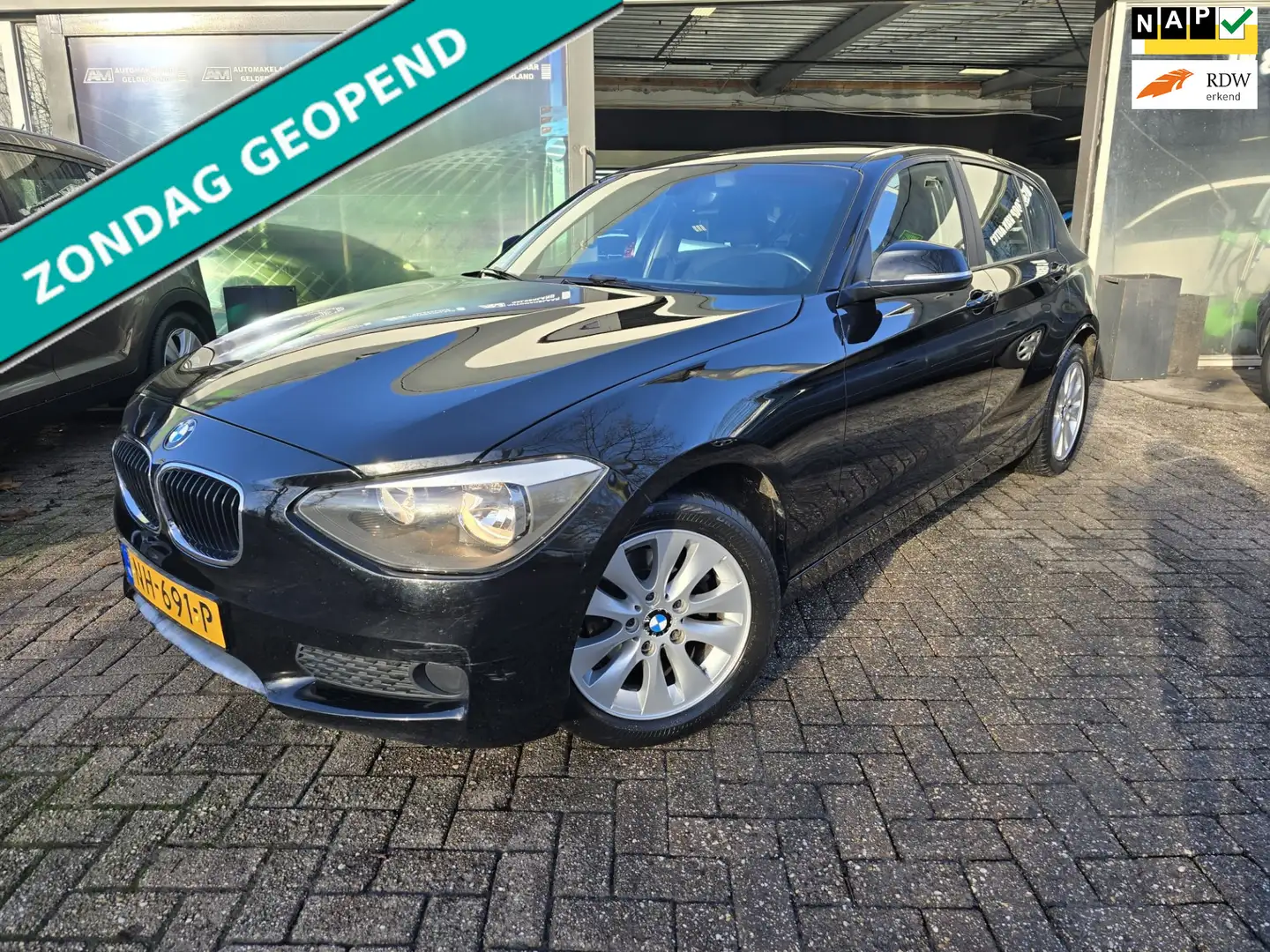 BMW 114 1-serie 114i EDE Executive | 12MND GARANTIE | AIRC Zwart - 1