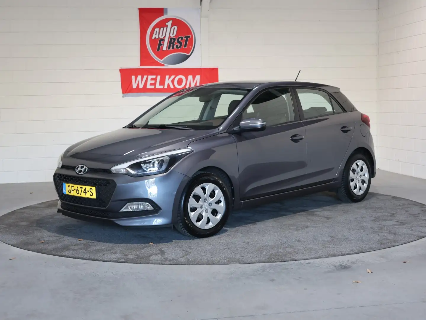Hyundai i20 1.2 HP i-Motion, Airco, Radio, Blue tooth tel, Iso Grijs - 1