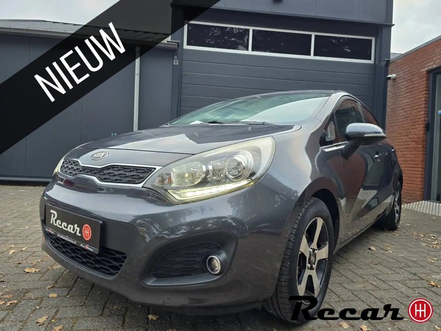 Kia Rio 1.2 CVVT Super Pack/KeyLess/Navi/Pdc/Cruise Grijs - 1