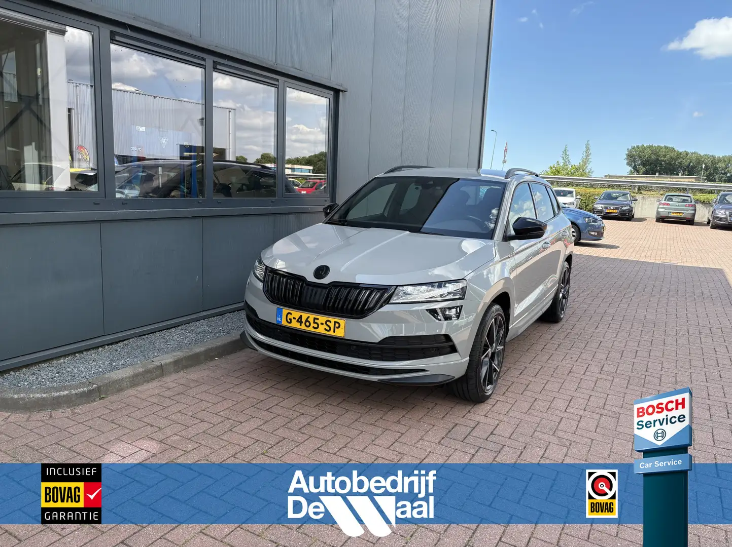 Skoda Karoq 1.5 TSi 150pk 4x4 DSG Scout Sportline Business CAM Grau - 1