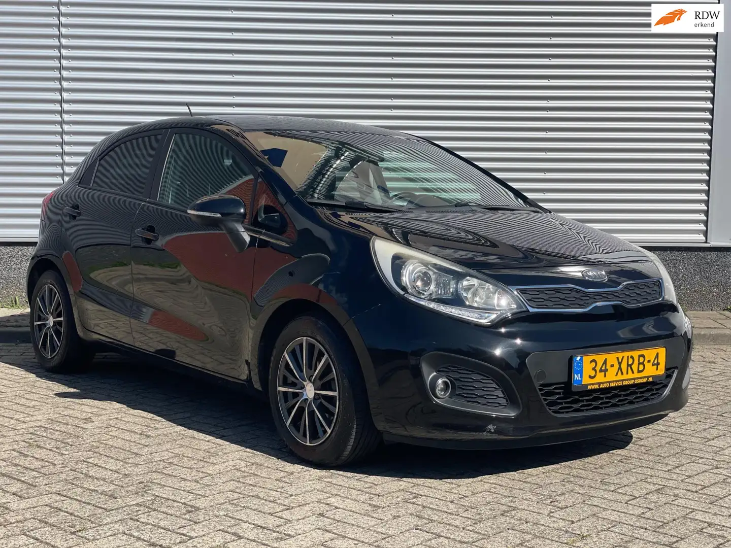 Kia Rio 1.2 CVVT Super Pack JAAR APK | KEYLESS | NAVI Zwart - 1