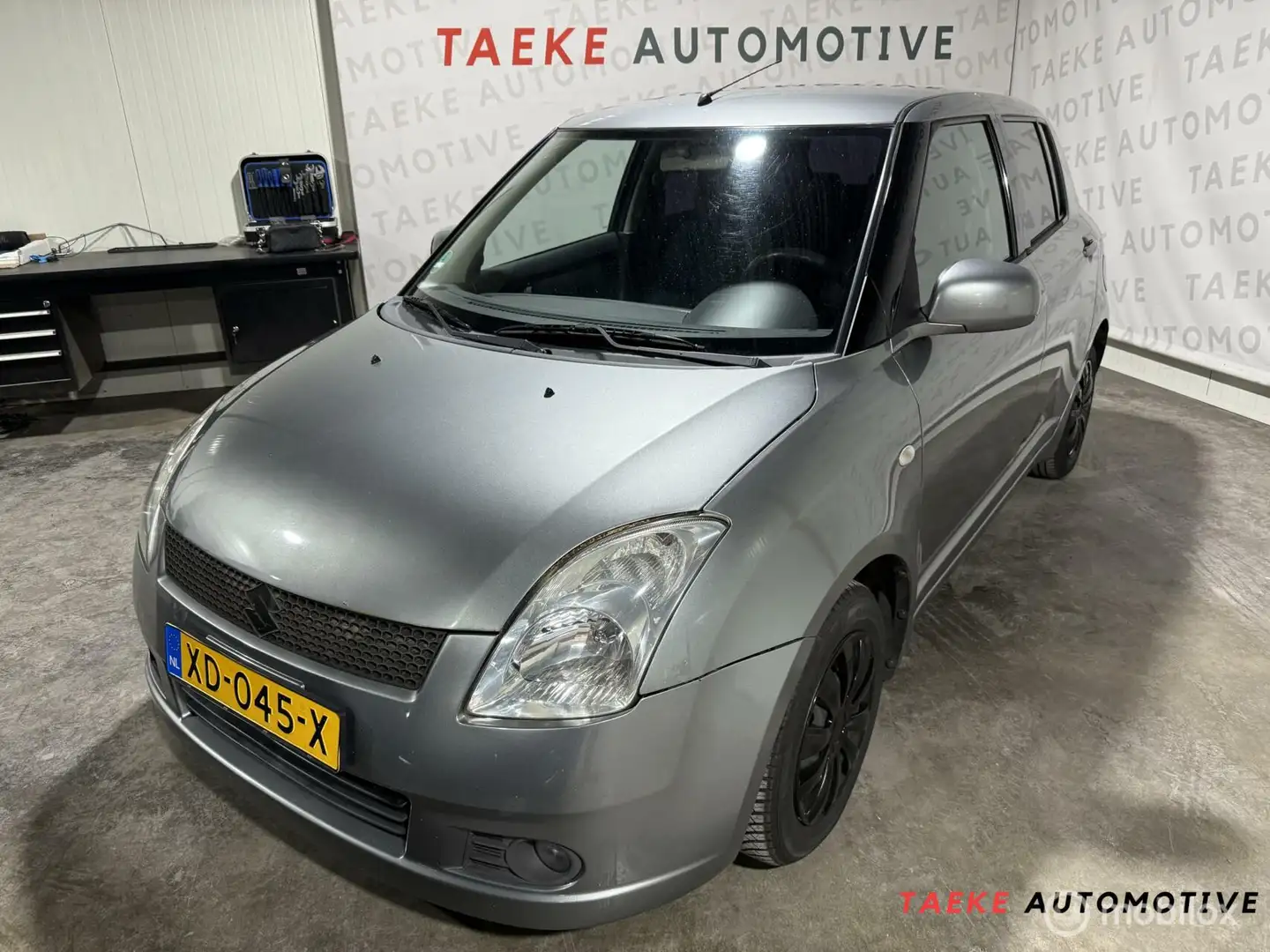 Suzuki Swift 1.3 GA Apk/Airco/Stoelverwarming/Lees tekst Grijs - 1