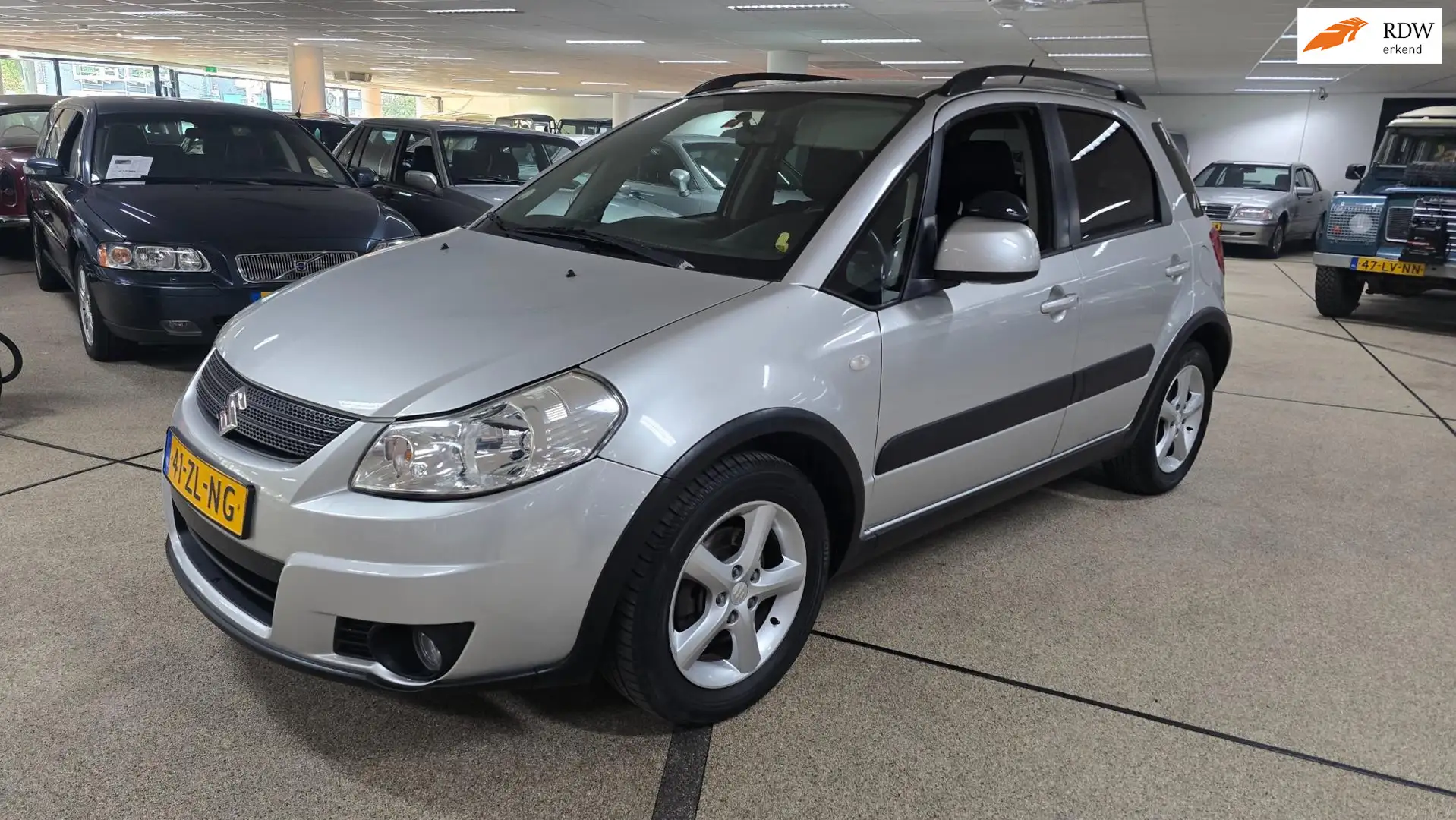 Suzuki SX4 1.6 Shogun zeer netjes Airco. Grijs - 1
