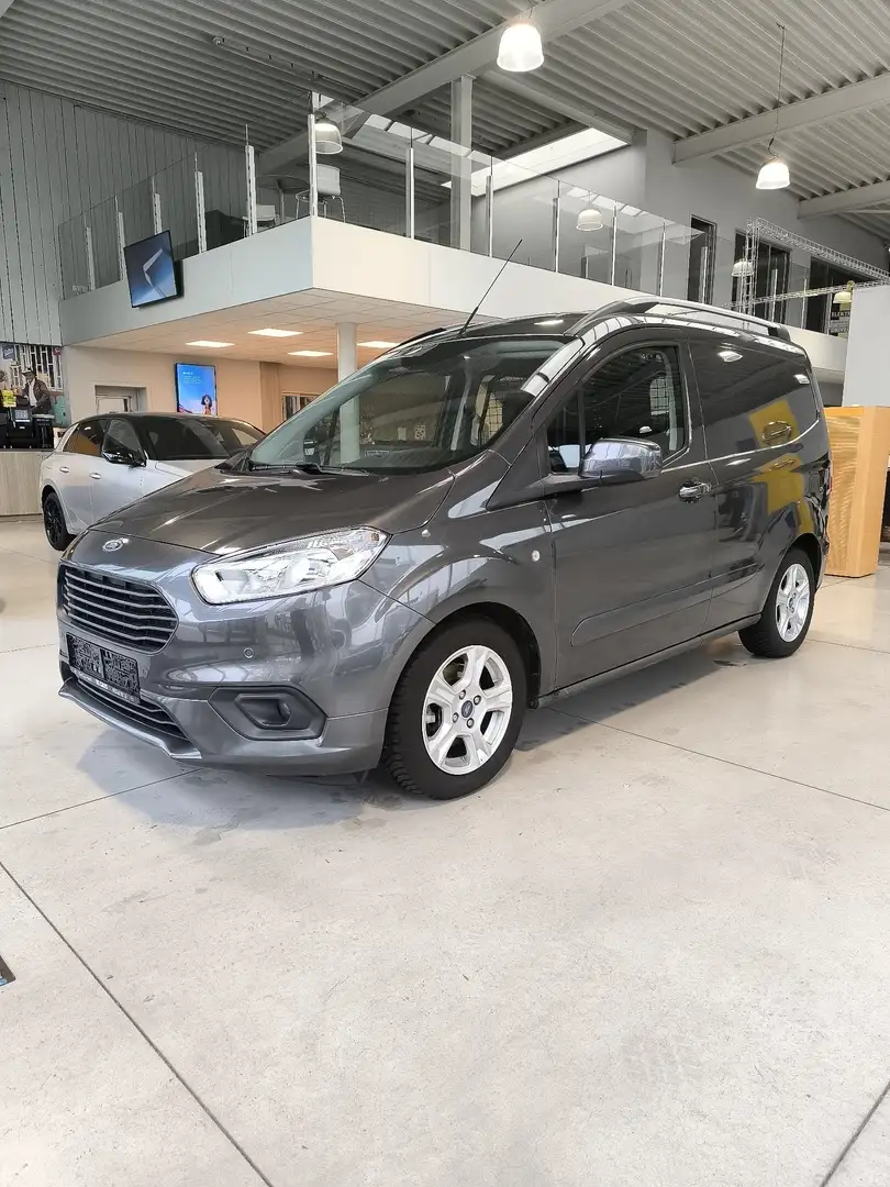 Ford Transit Courier 1.0TURBO*Park.Sen V/A+CAM*Navi*Trekh*CruisC*AppCP* Zilver - 1