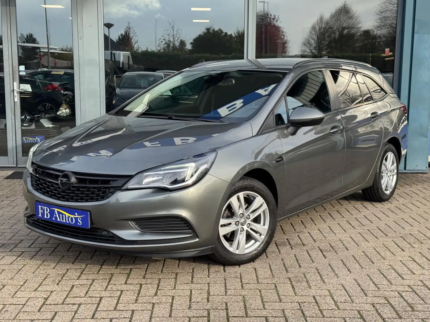 Opel Astra Sports Tourer 1.0 Online Edition Airco Navi Cruise Grijs - 1