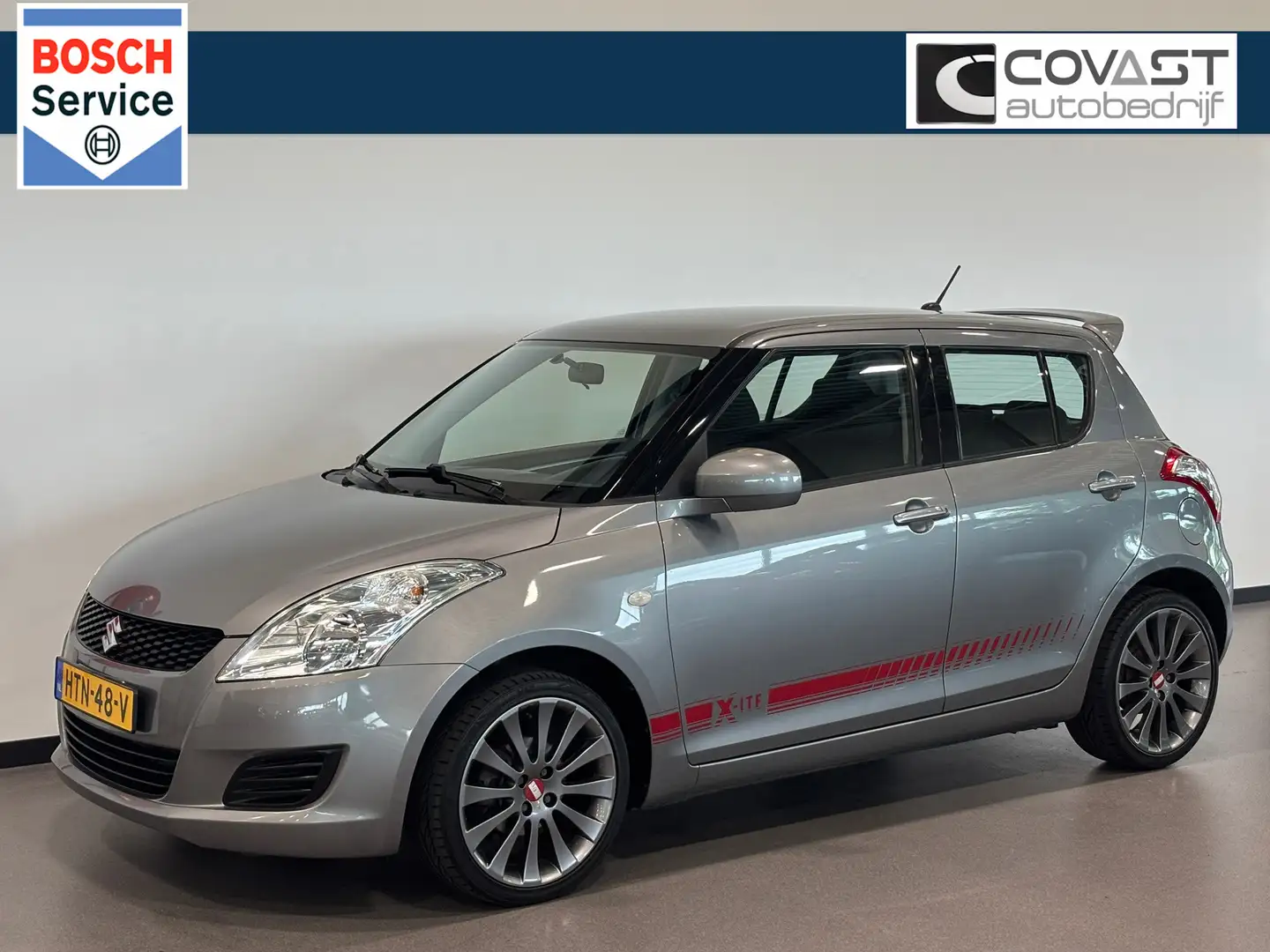 Suzuki Swift 1.2 X-ite 5-Deurs|Airco|LMV Grijs - 1